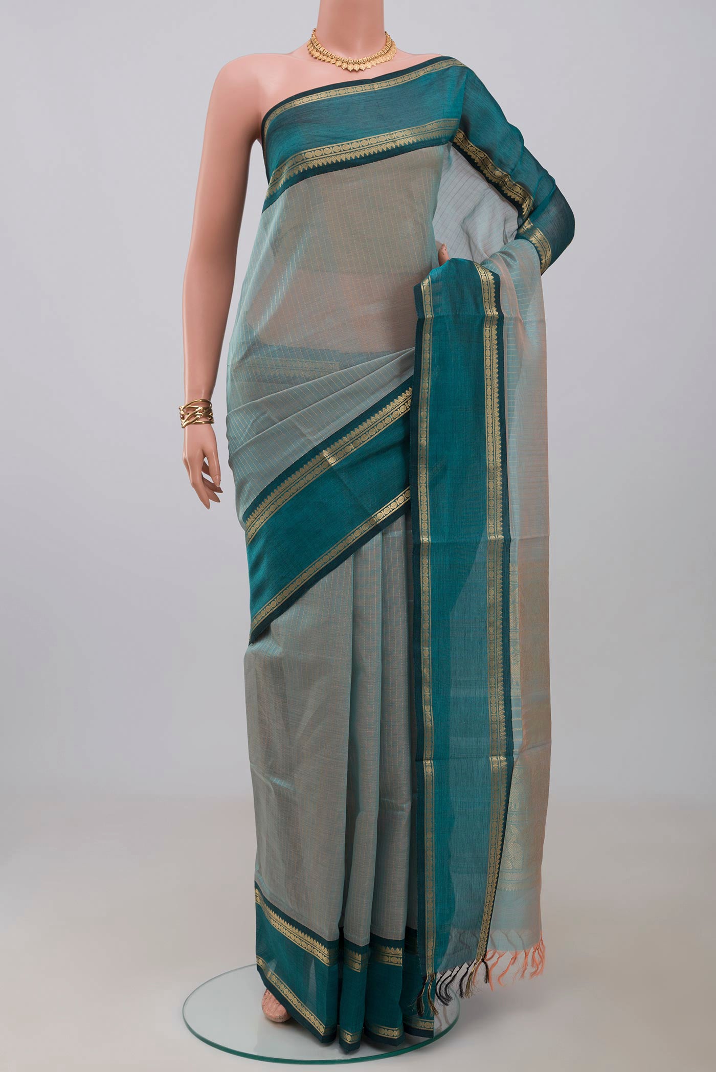 Light Blue Silk Cotton Saree with Stripes on the body and Zari Border.  displayed on a mannequin