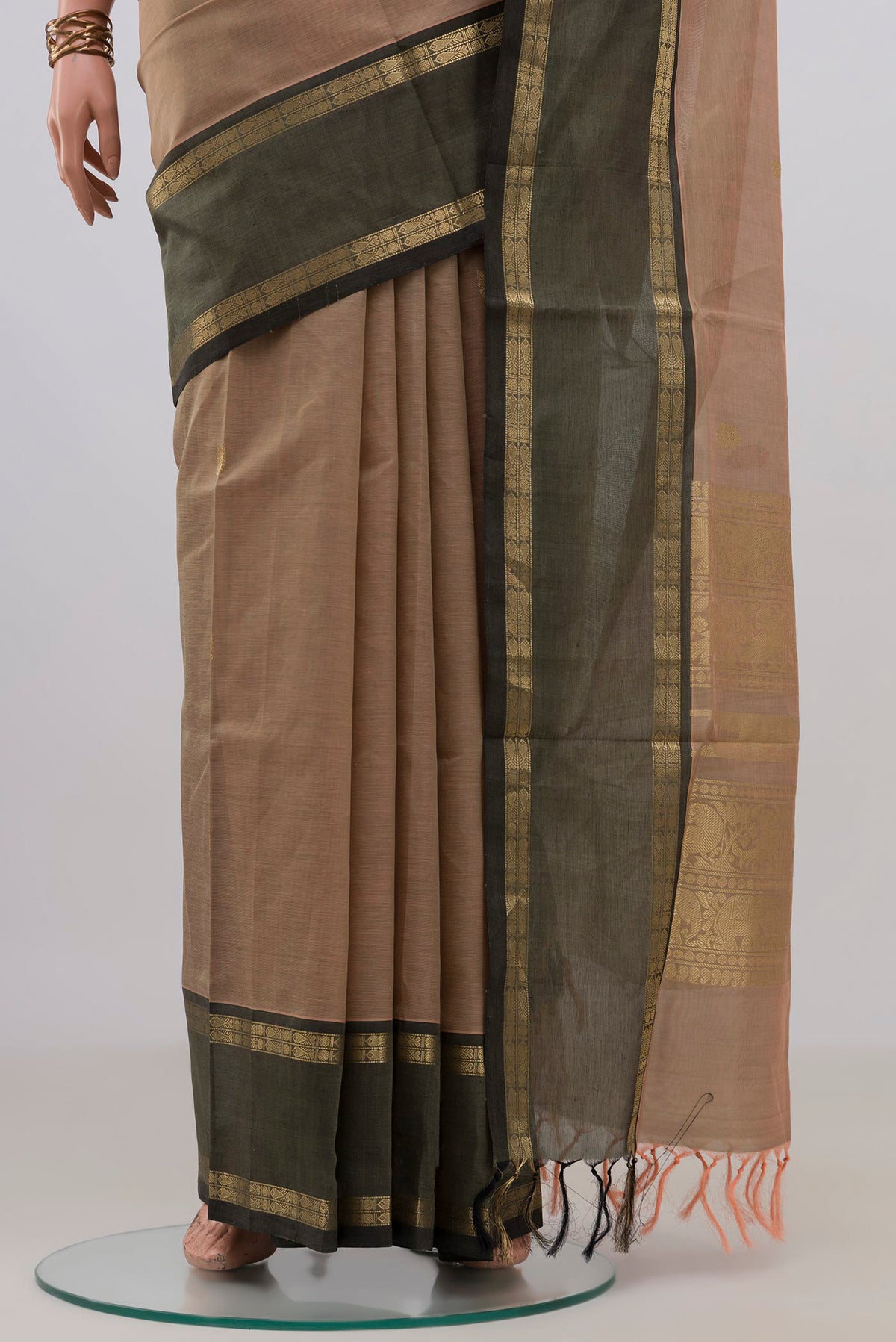 Pleats and pallu of Beige Silk Cotton Saree with Zari Butta on the body and Zari Border. 