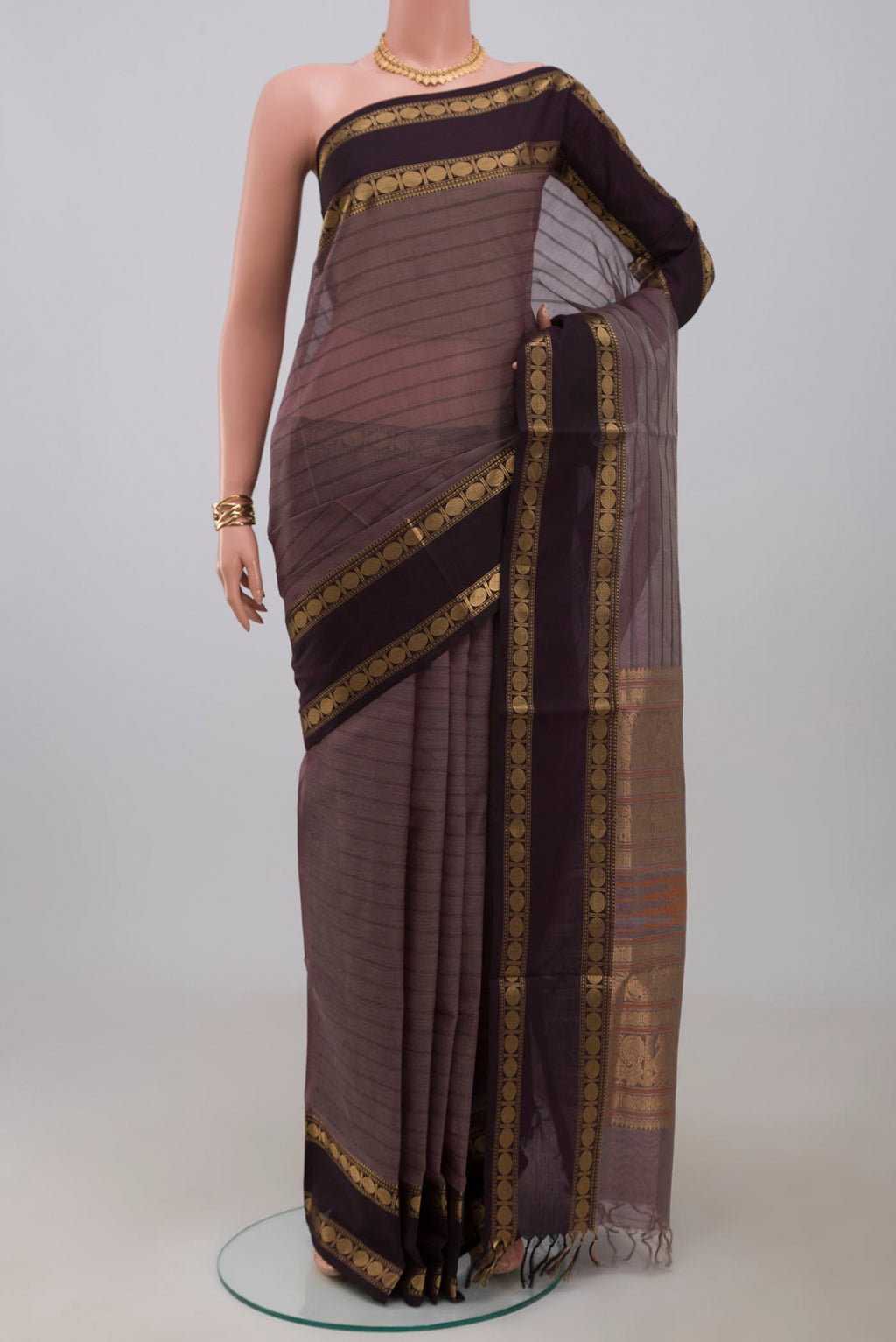 Grey Silk Cotton Saree with Veldhari on the body and Zari Border.  displayed on a mannequin