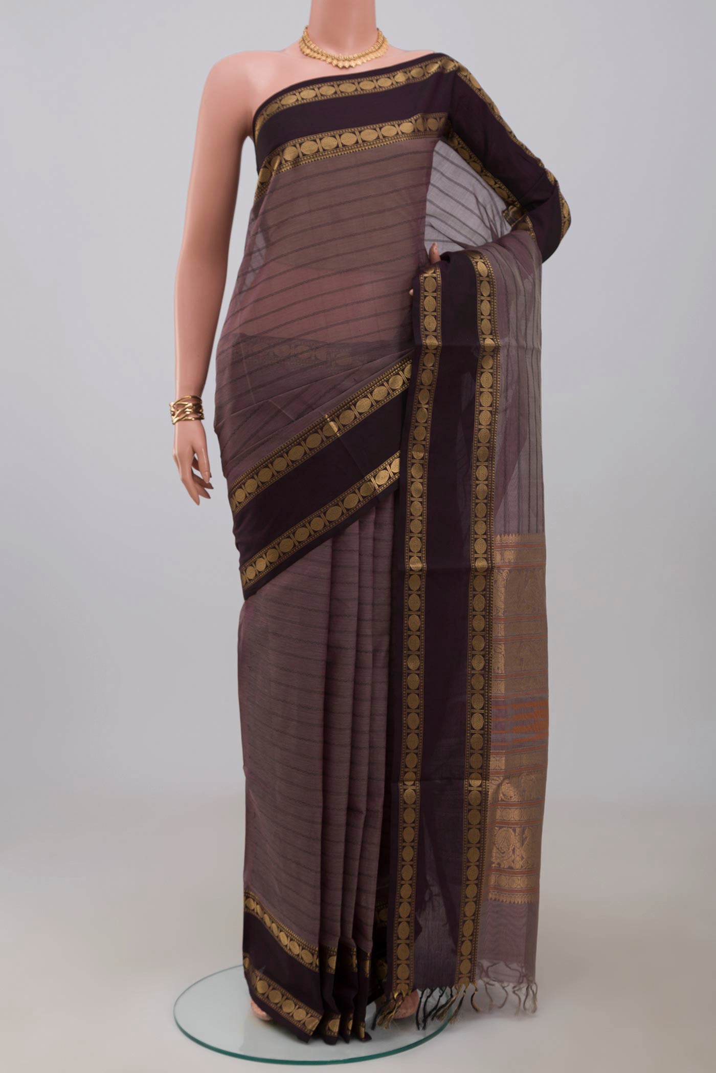 Grey Silk Cotton Saree with Veldhari on the body and Zari Border.  displayed on a mannequin
