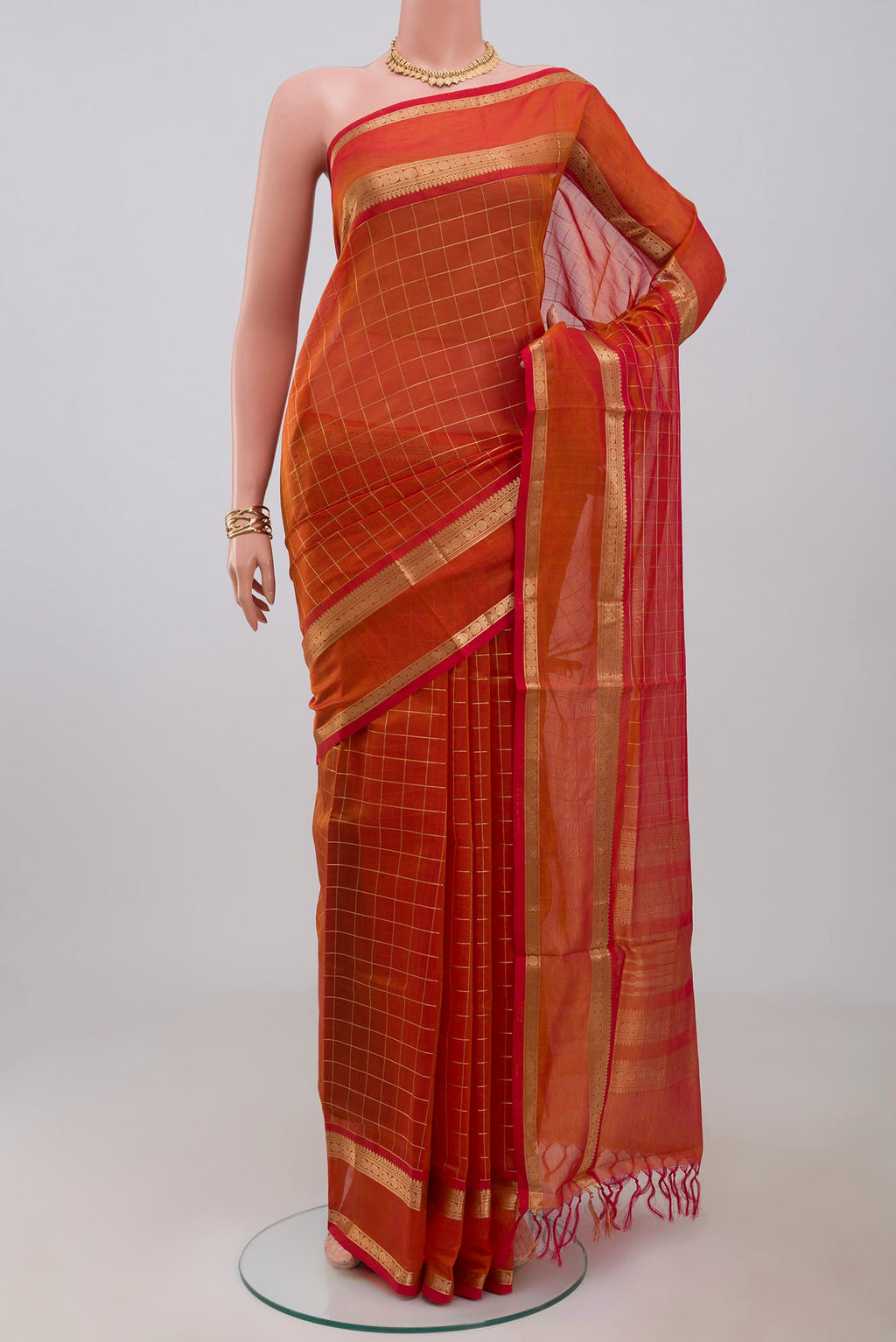 Orange Silk Cotton Saree with Checked design on the body and Zari Border.  displayed on a mannequin