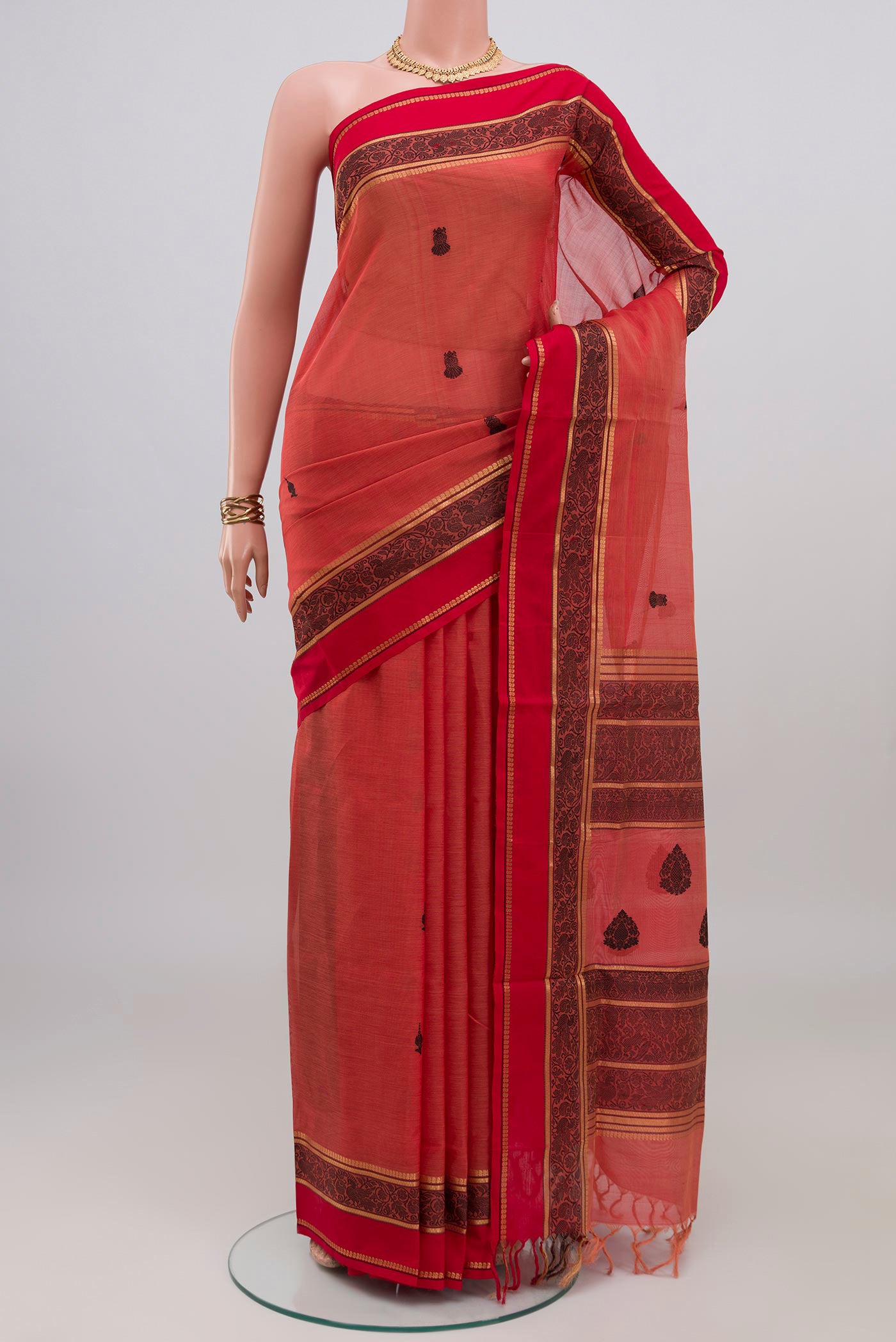 Coral Silk Cotton Saree with Thread Butta on the body and Thread Border.  displayed on a mannequin