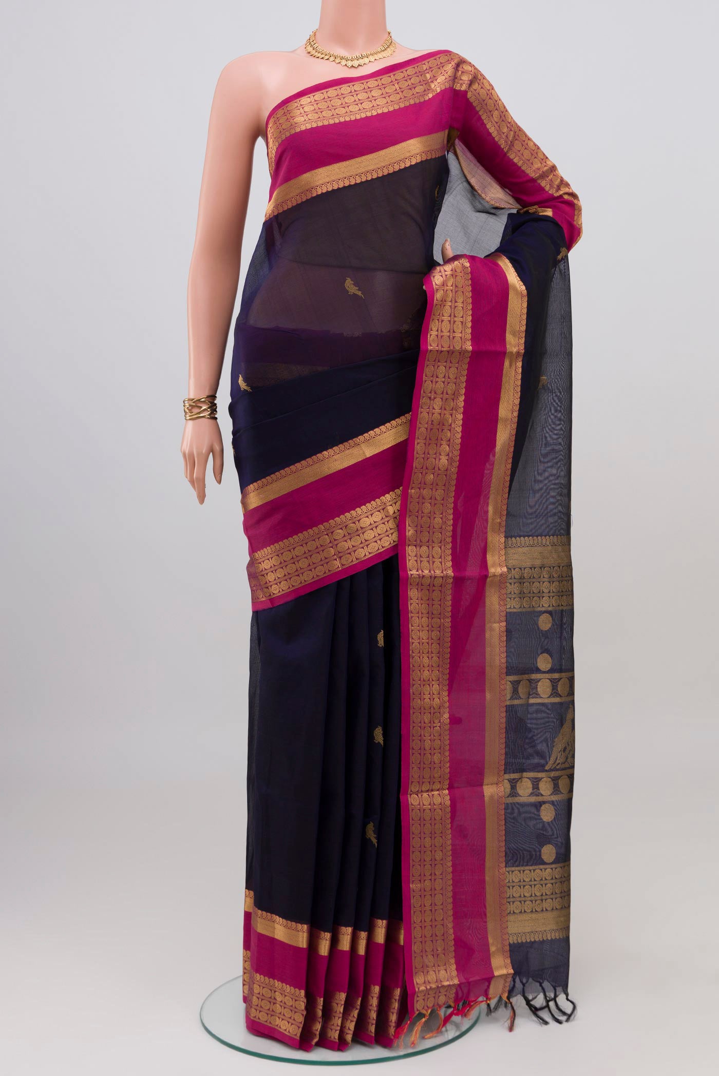 Navy Blue Silk Cotton Saree with Zari Butta on the body and Zari Border.  displayed on a mannequin