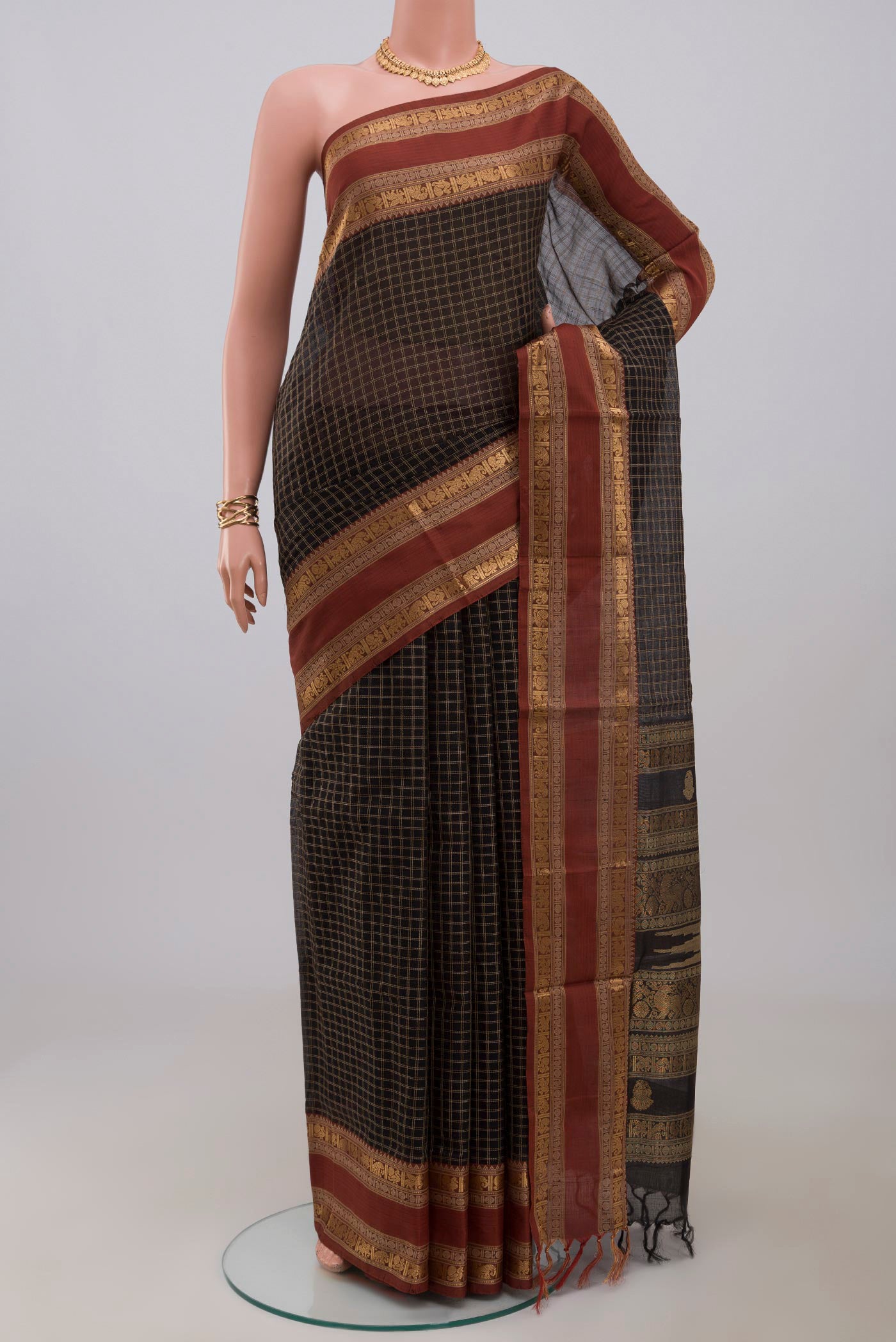 Black Silk Cotton Saree with Checked design on the body and Zari Border.  displayed on a mannequin