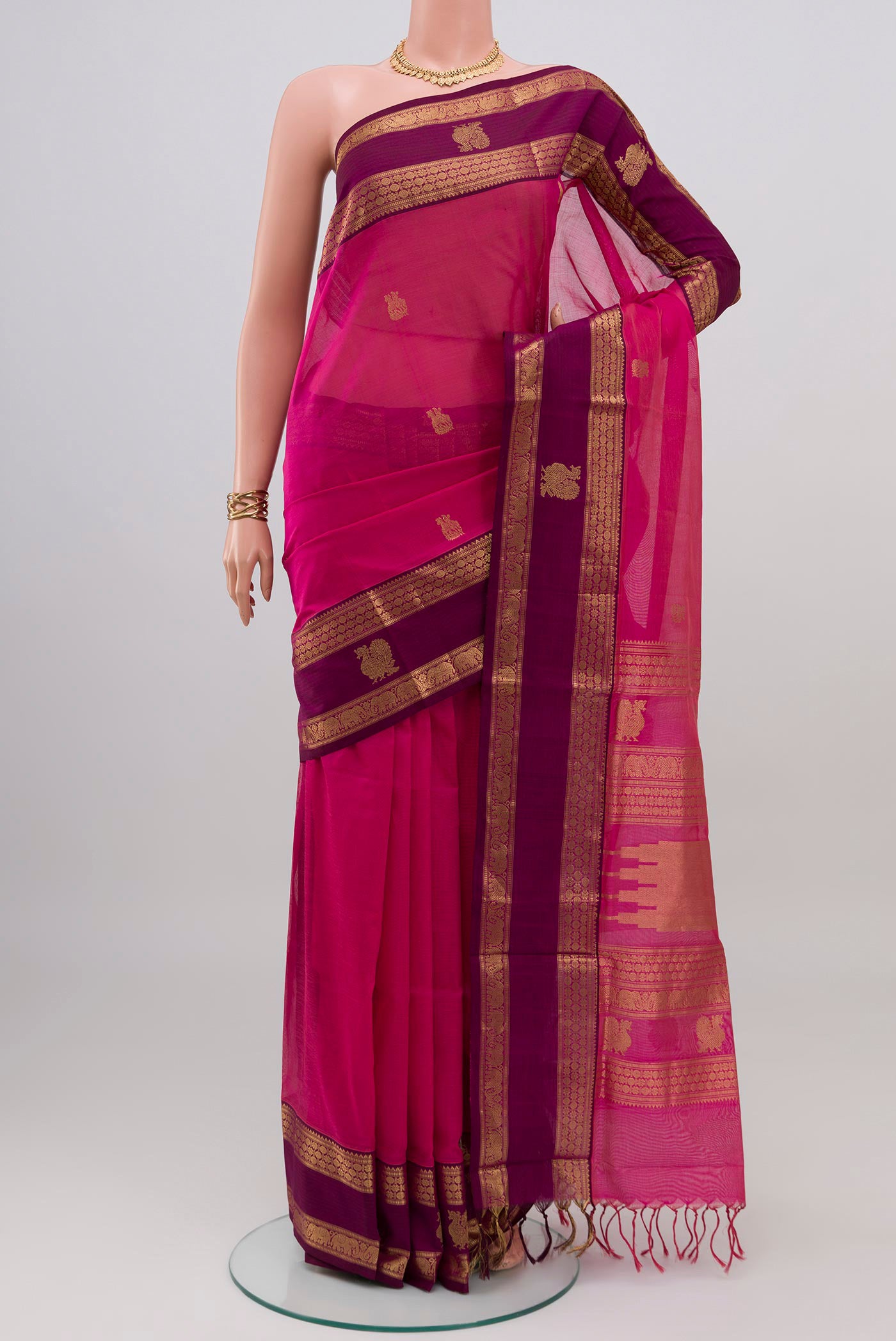 Pink Silk Cotton Saree with Zari Butta on the body and Zari Border.  displayed on a mannequin