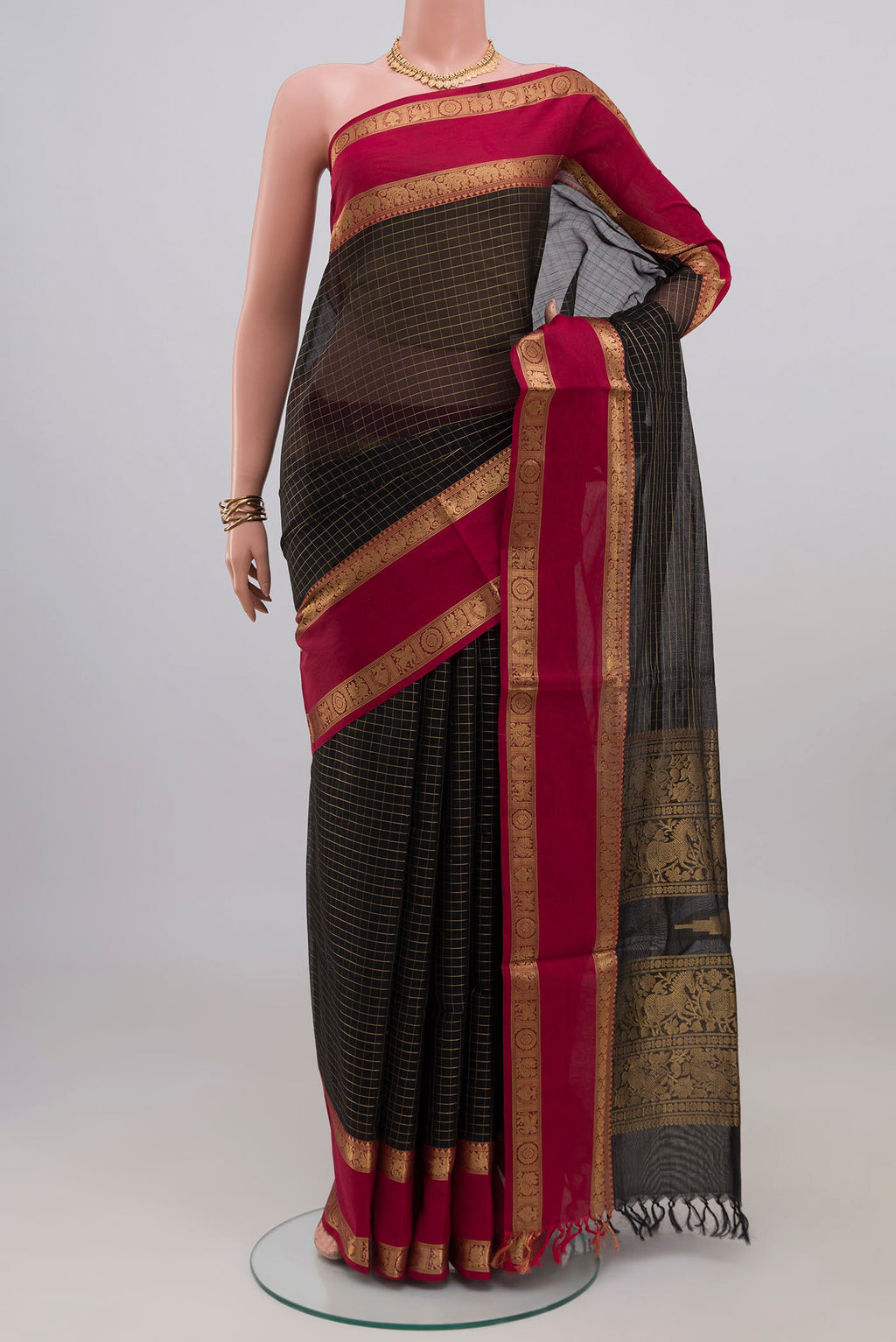 Black Silk Cotton Saree with Checked design on the body and Zari Border.  displayed on a mannequin