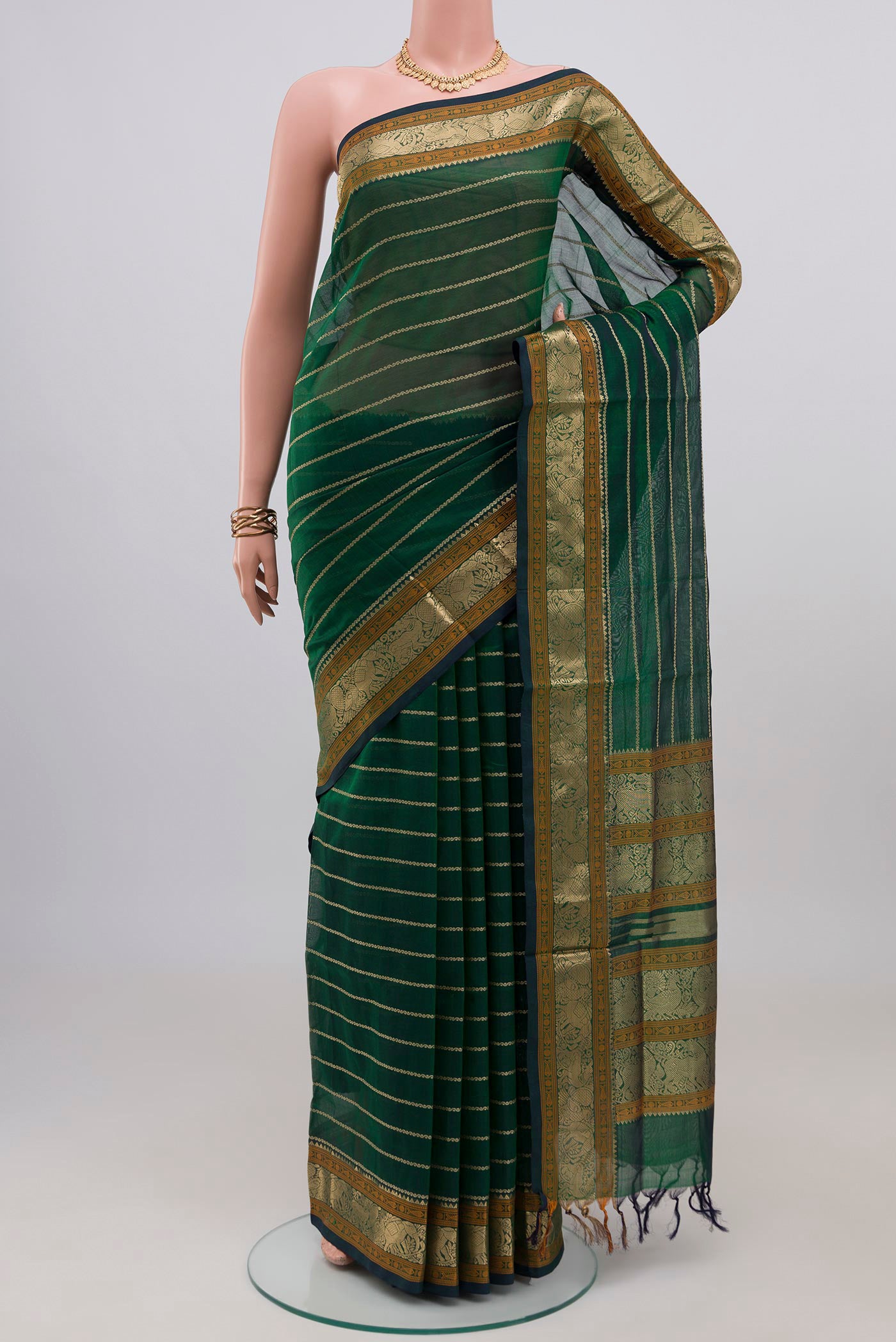 Green Dual Tone Silk Cotton Saree with Veldhari on the body and Zari Border.  displayed on a mannequin