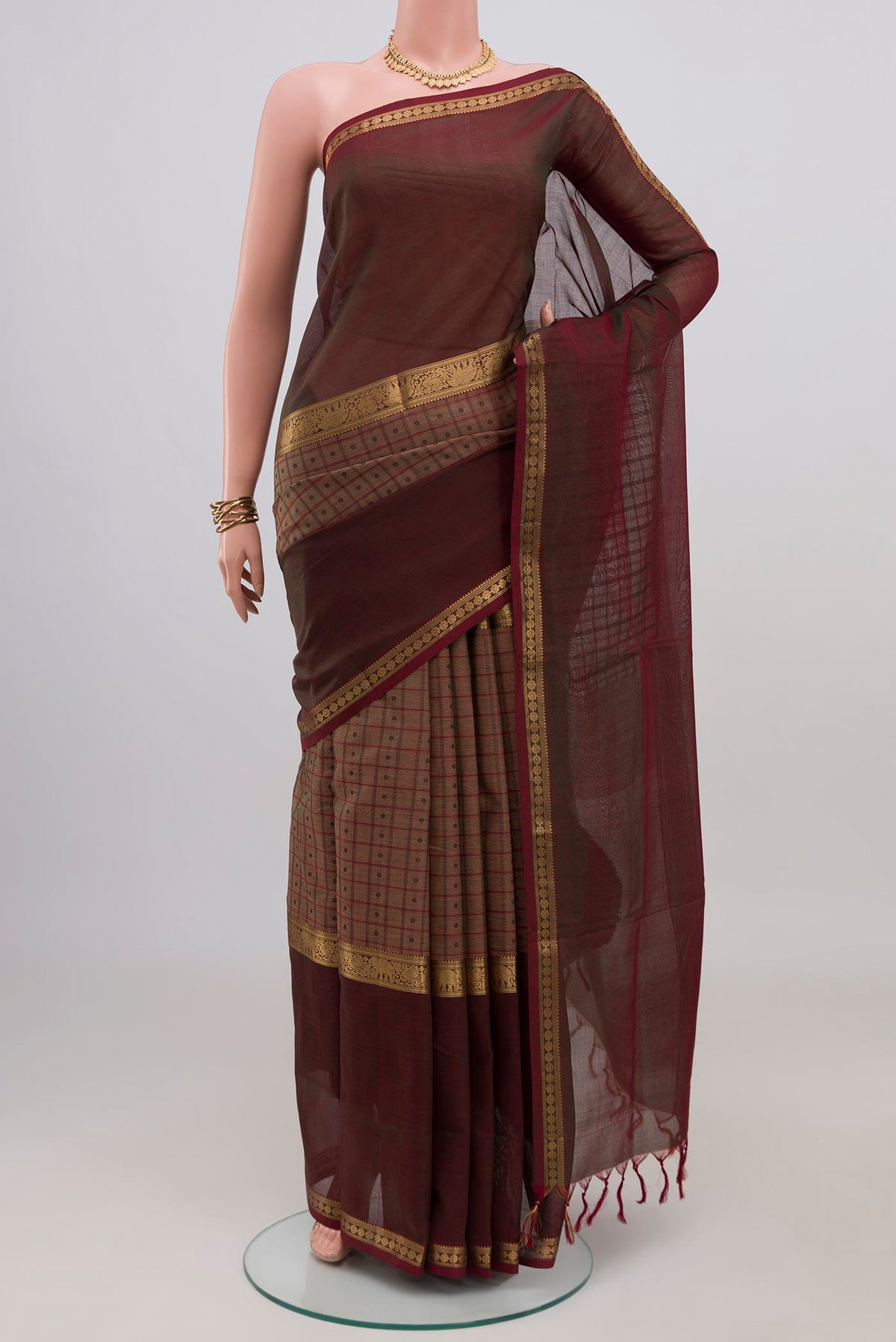 Brown Silk Cotton Saree with Checked design on the body and Zari Border.  displayed on a mannequin