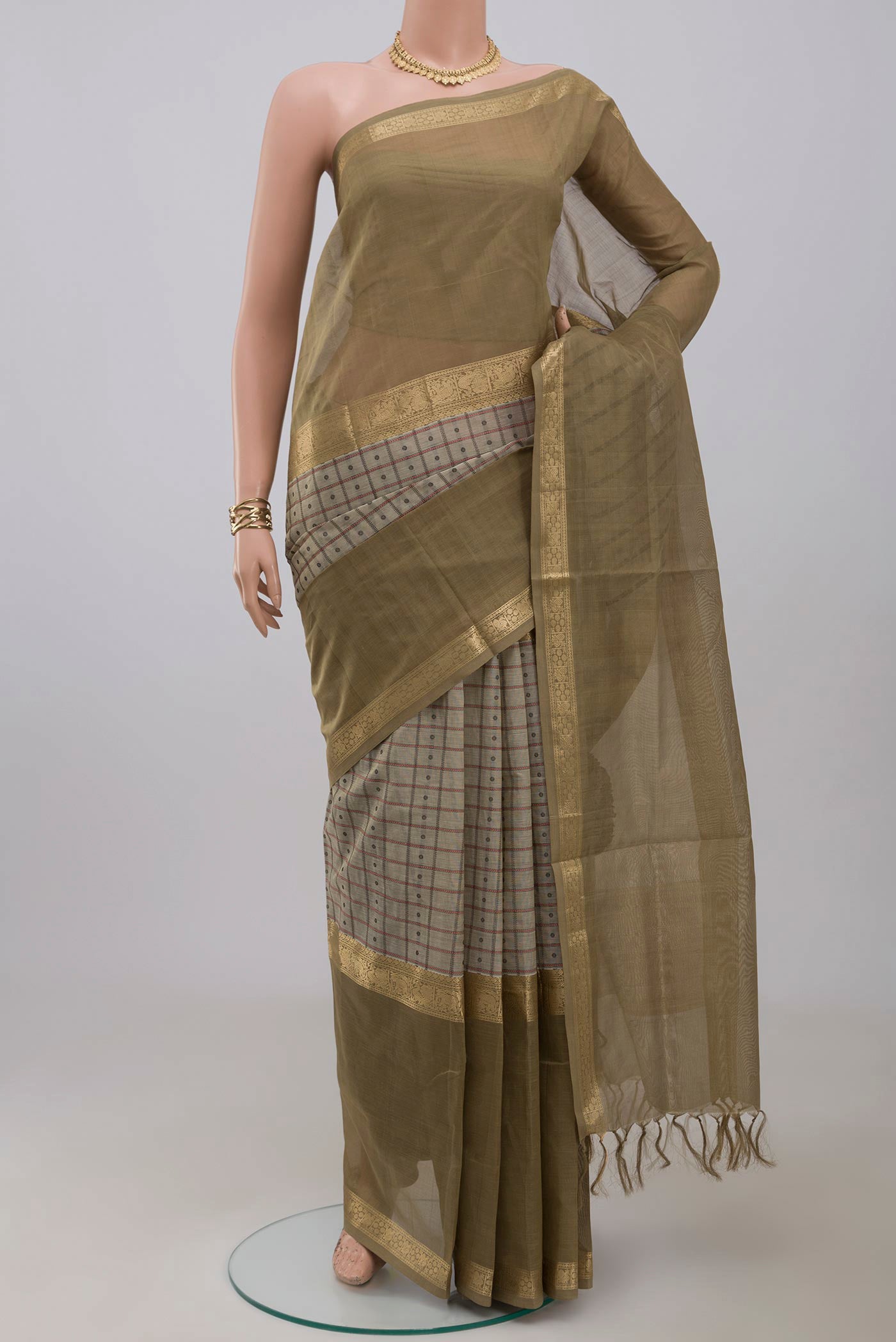 Cream Silk Cotton Saree with Checked design on the body and Zari Border.  displayed on a mannequin