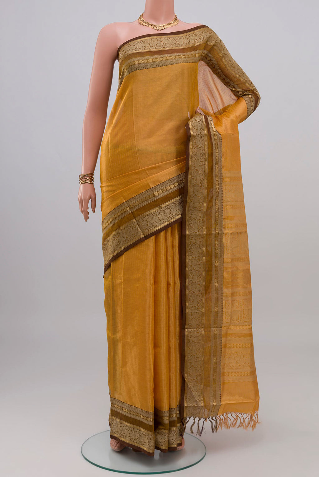 Yellow Silk Cotton Saree with Stripes on the body and Zari Border.  displayed on a mannequin