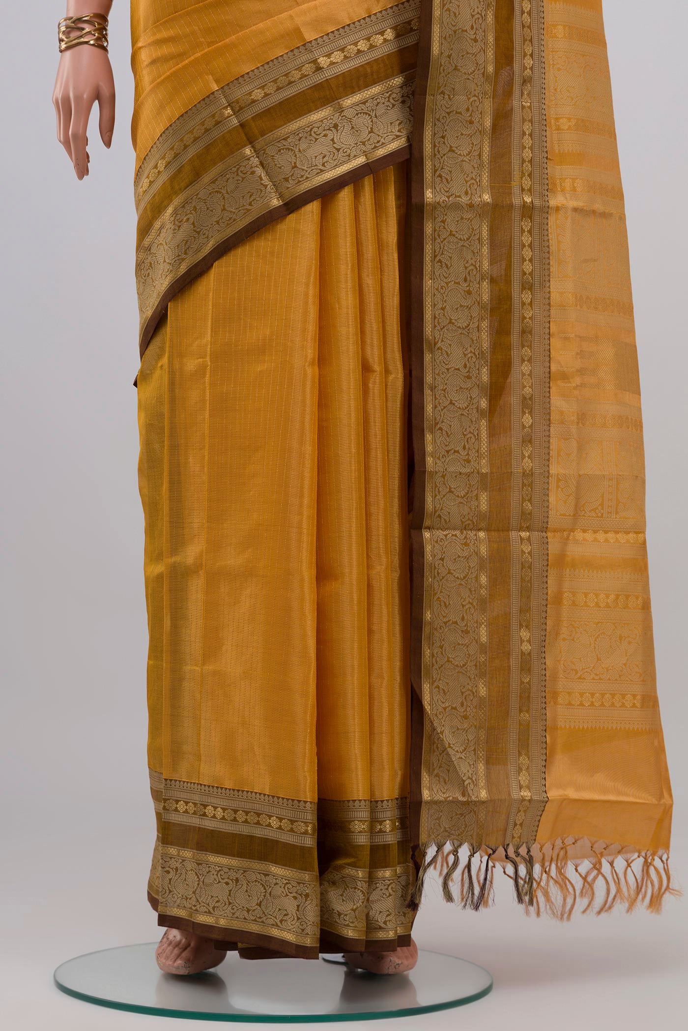 Pleats and pallu of Yellow Silk Cotton Saree with Stripes on the body and Zari Border. 