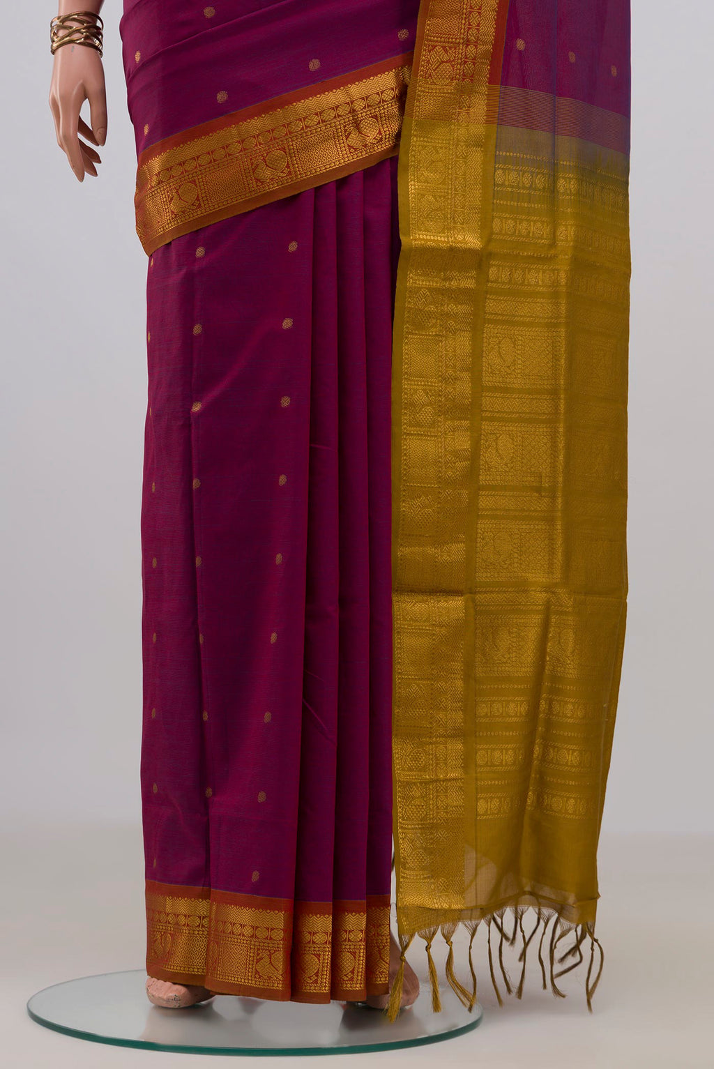 Pleats and pallu of Purple Blended Poly Cotton Saree with Zari Butta on the body and Zari Border. 