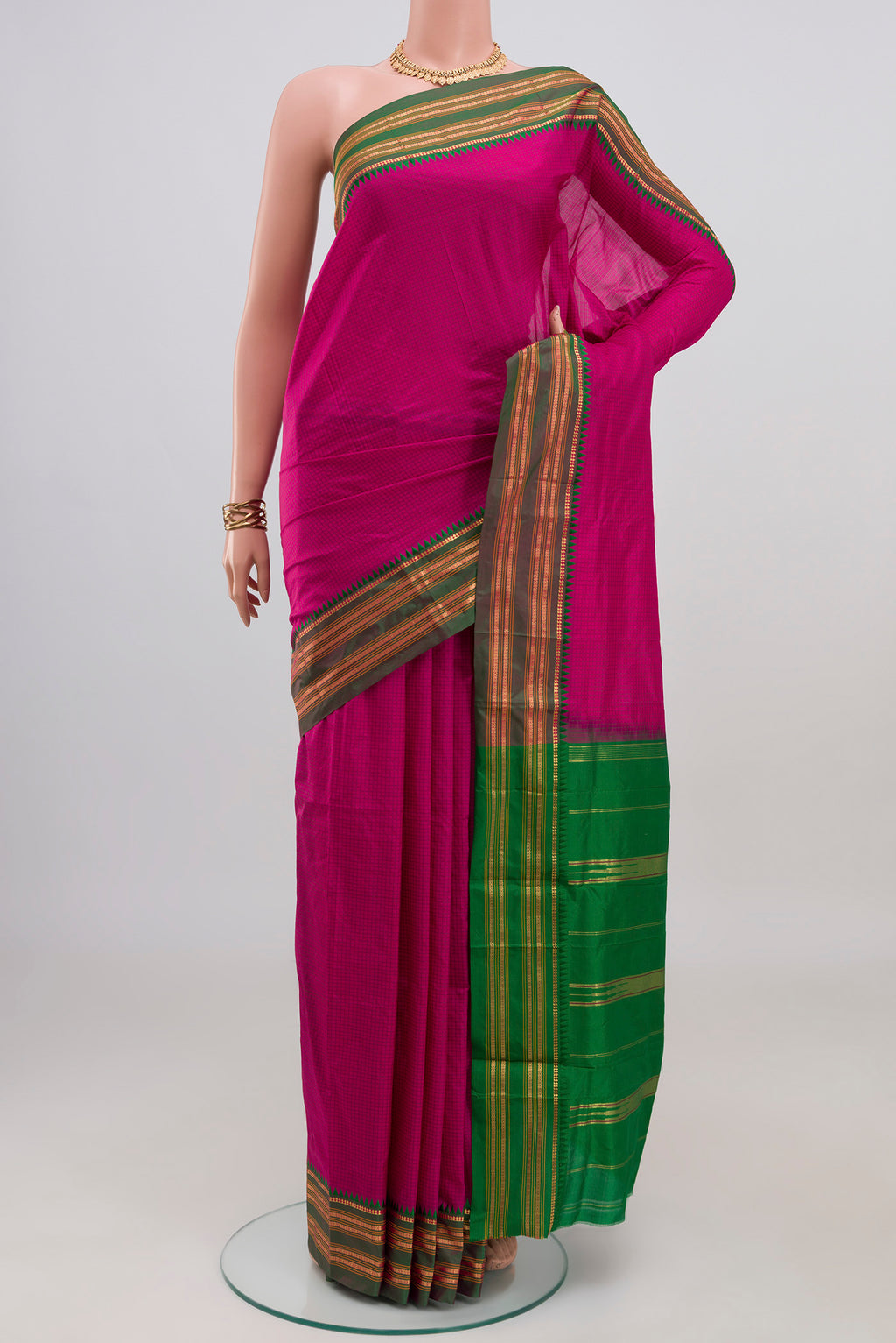 Rani Pink Narayanpet Silk Saree with Checked design on the body and Zari Border.  displayed on a mannequin