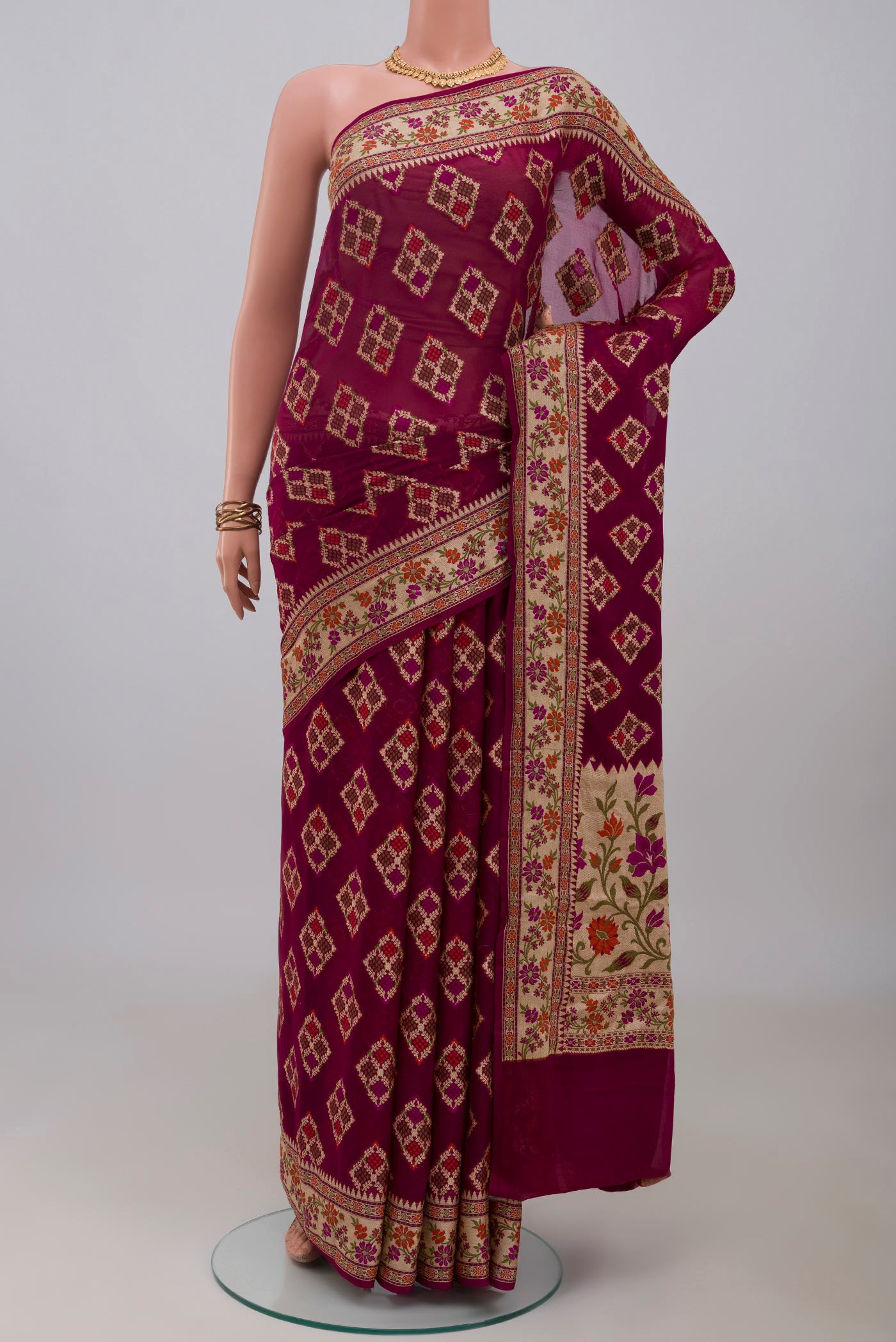 Magenta Banarasi Georgette Saree with Thread Butta on the body and Thread Border.  displayed on a mannequin