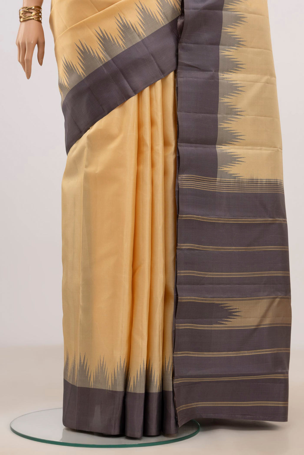 Pleats and pallu of Sandal Kanchipuram Silk Saree with Plain Body and Temple Border. 