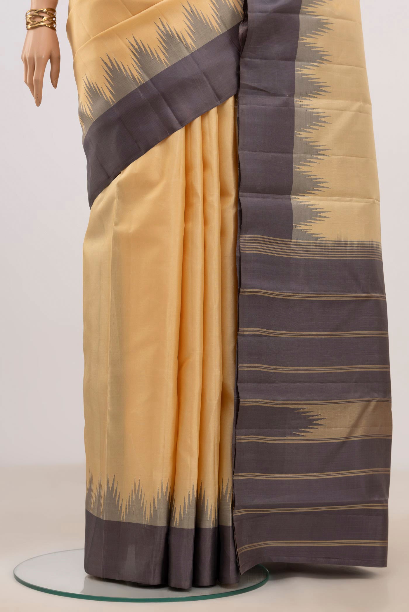 Pleats and pallu of Sandal Kanchipuram Silk Saree with Plain Body and Temple Border. 