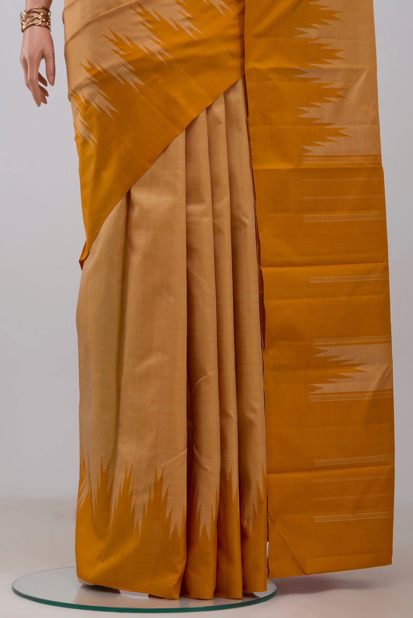 Pleats and pallu of Sandal Kanchipuram Silk Saree with Plain Body and Temple Border. 