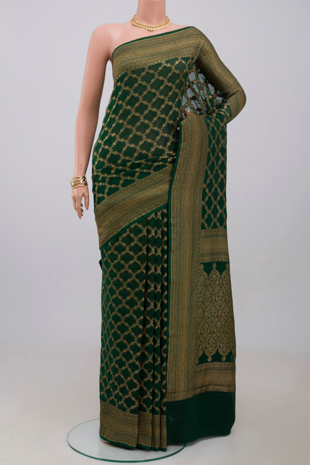 Green Georgette Saree with Fancy on the body and Zari Border.  displayed on a mannequin