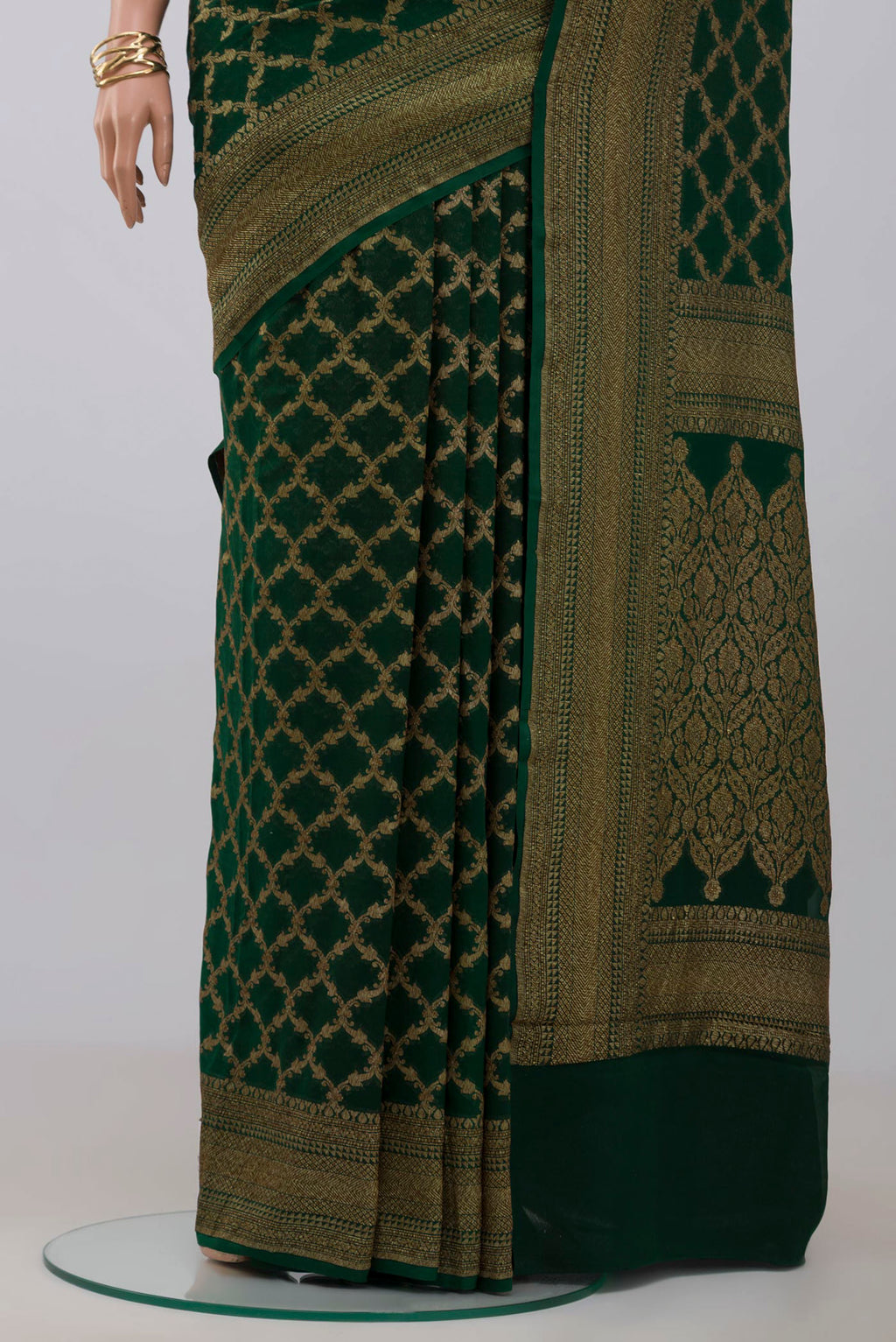 Pleats and pallu of Green Georgette Saree with Fancy on the body and Zari Border. 