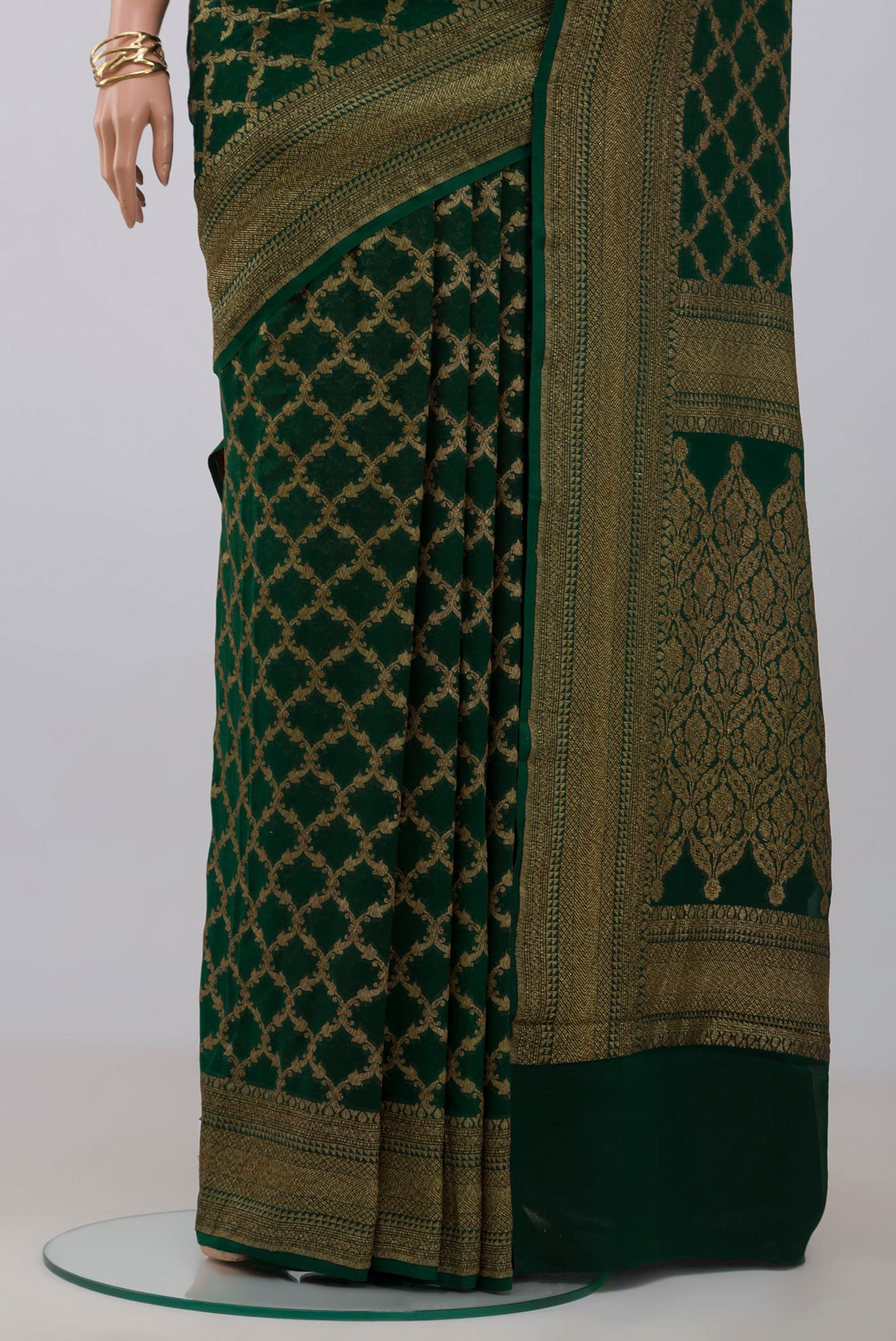 Pleats and pallu of Green Georgette Saree with Fancy on the body and Zari Border. 