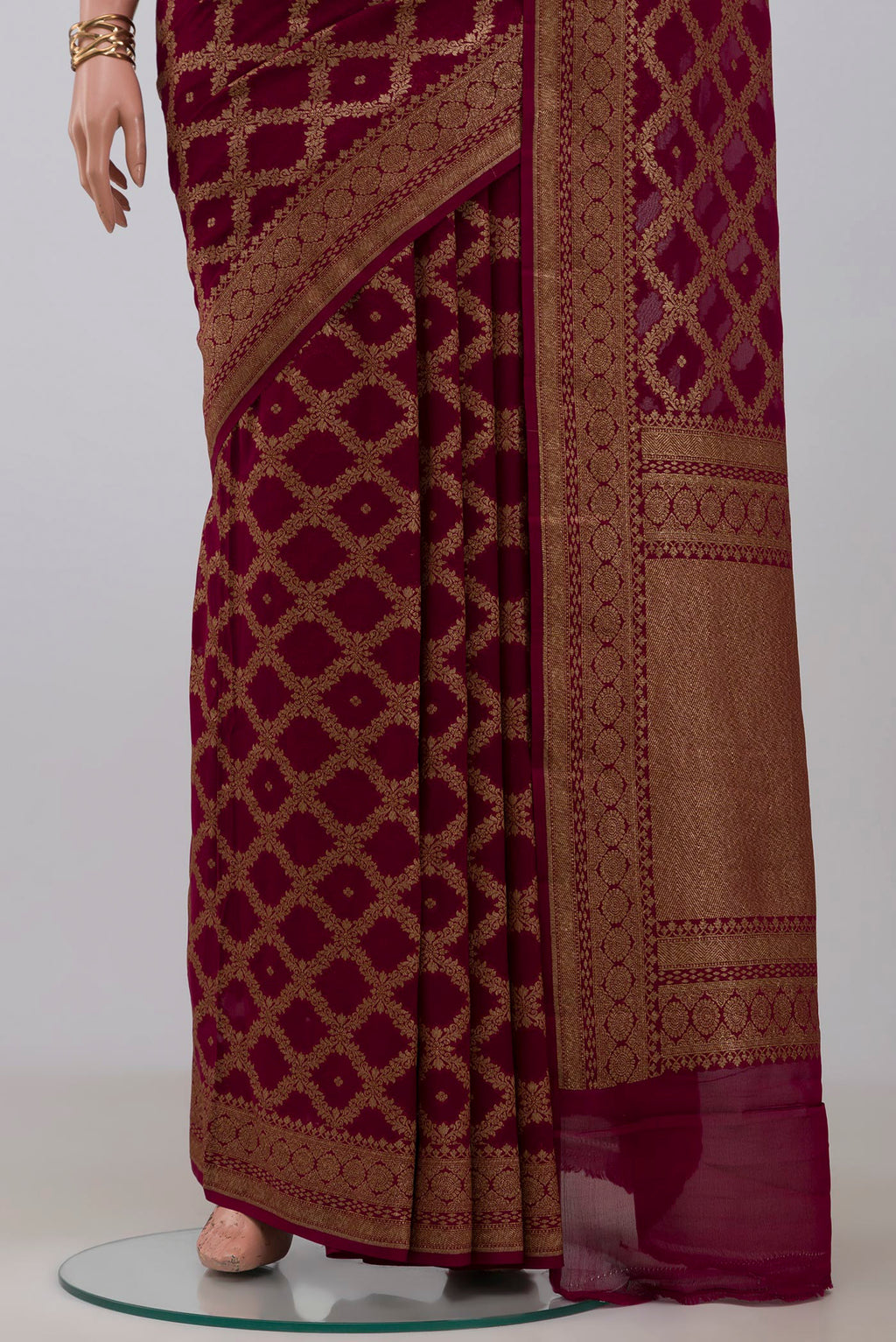 Pleats and pallu of Maroon Georgette Saree with Fancy on the body and Fancy Border. 