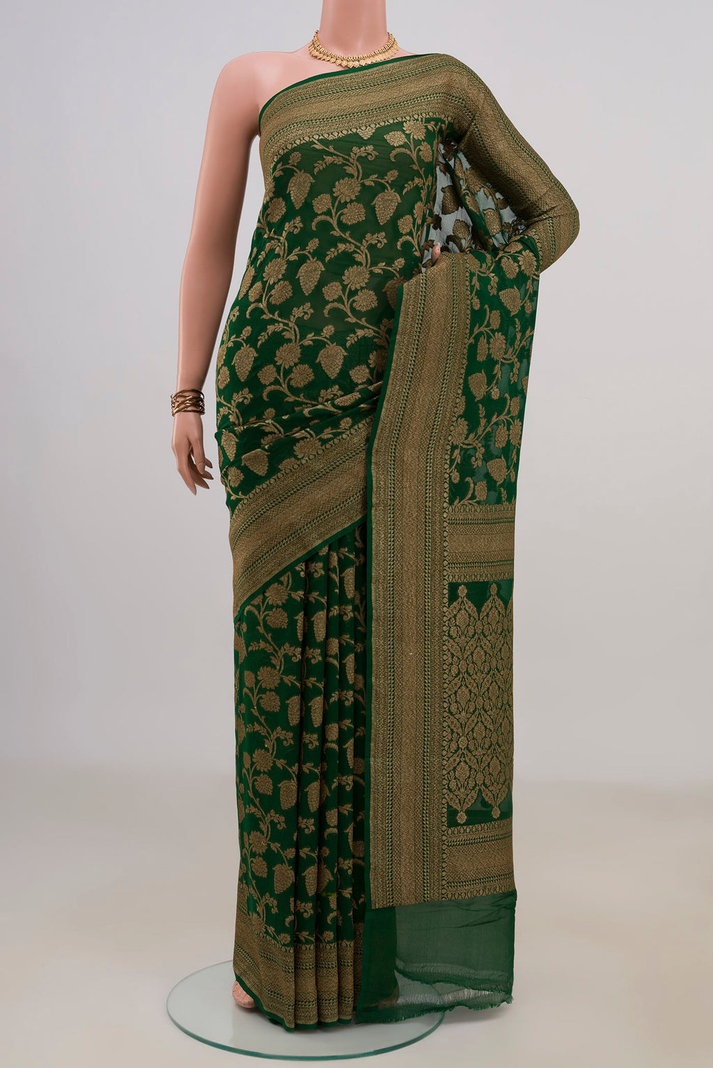 Bottle Green Banarasi Georgette Saree with Zari Brocade on the body and Fancy Border.  displayed on a mannequin