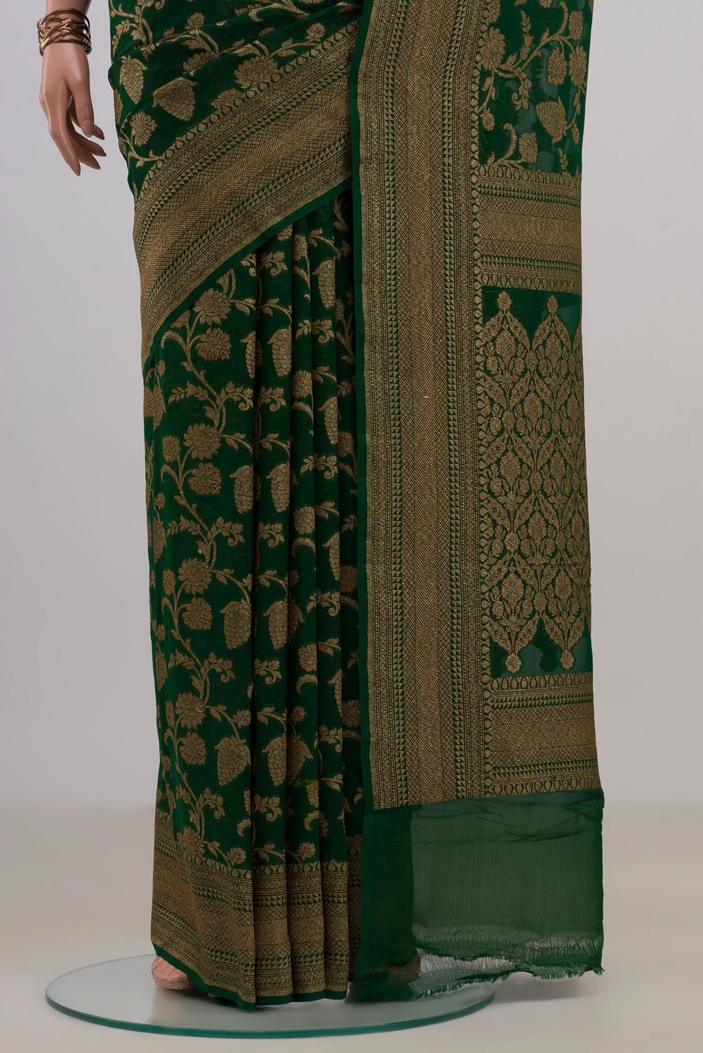 Pleats and pallu of Bottle Green Banarasi Georgette Saree with Zari Brocade on the body and Fancy Border. 