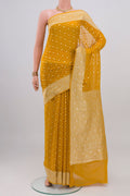 Mustard Banarasi Georgette Saree with Zari Butta on the body and Zari Border.  displayed on a mannequin