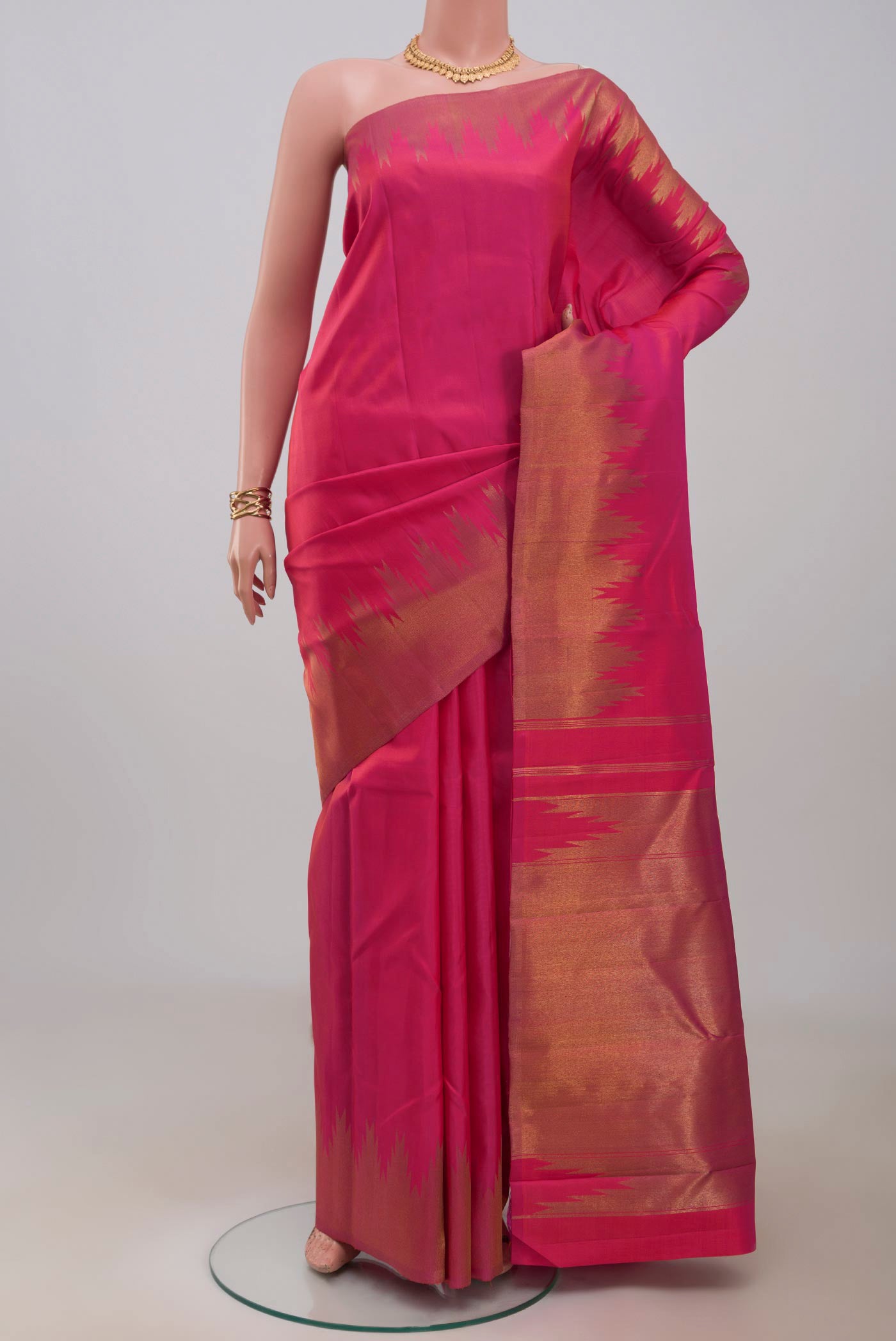 Pure Silk Pure Zari Pink Kanchipuram Saree with Plain Body and Temple Border.  displayed on a mannequin