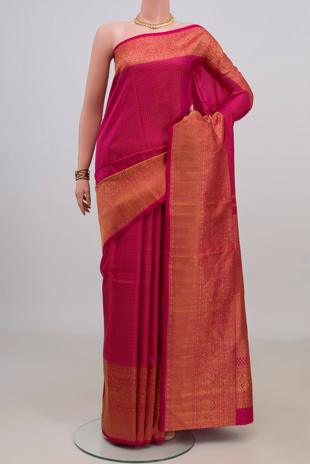 Pure Silk Pink Kanchipuram Saree with Checked design on the body and Fancy Border.  displayed on a mannequin