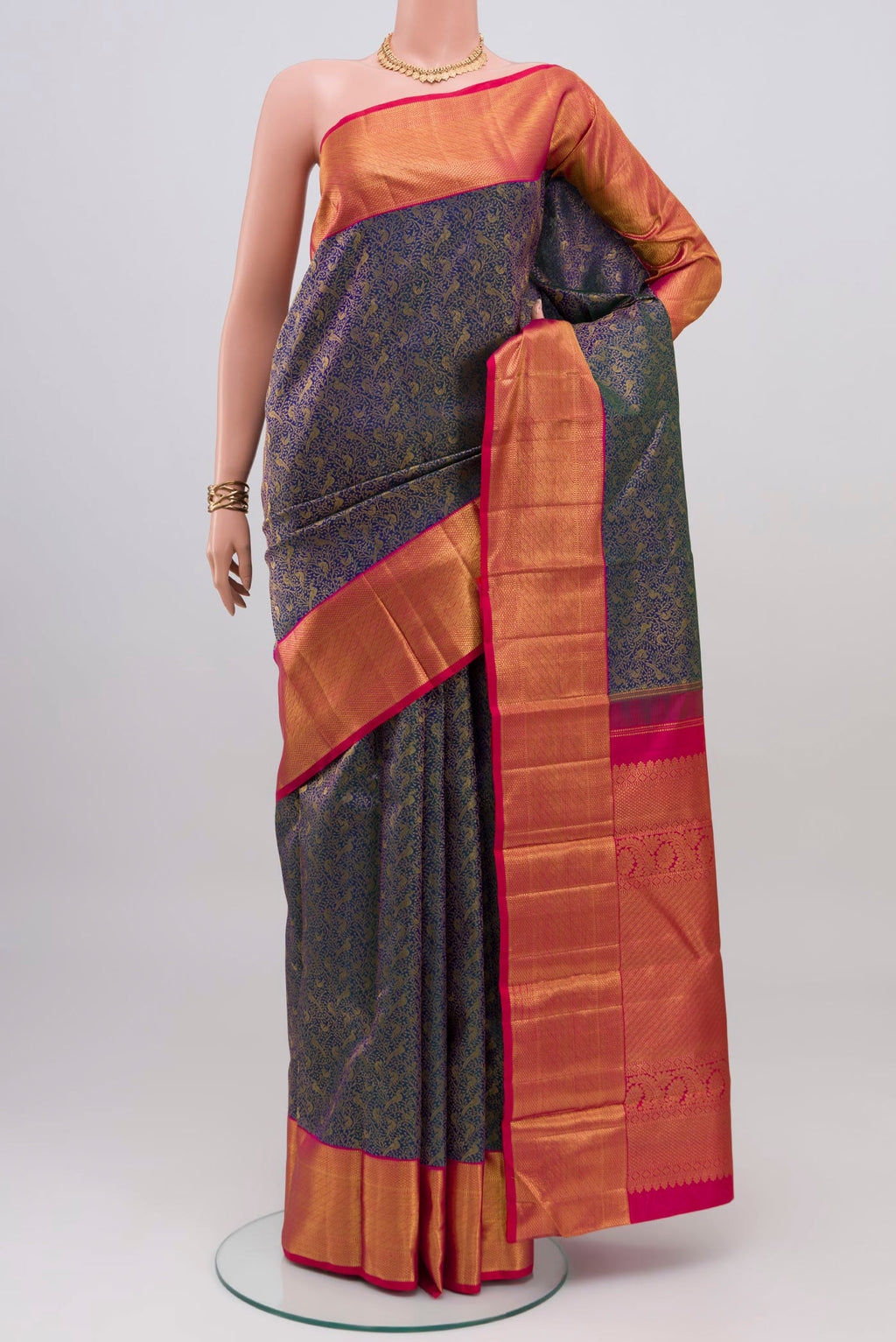 Blue Kanchipuram Silk Saree with Zari Brocade on the body and Zari Border.  displayed on a mannequin