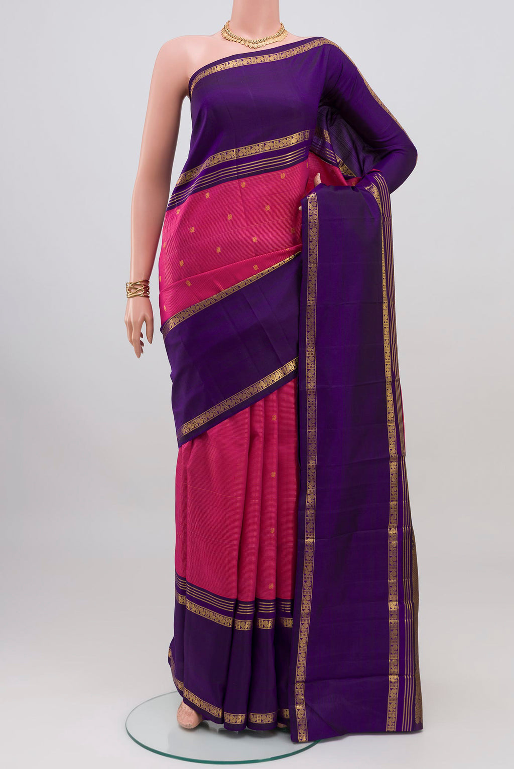 Pink Kanjivaram Silk Saree with Zari Butta on the body and Thin Zari Line.  displayed on a mannequin