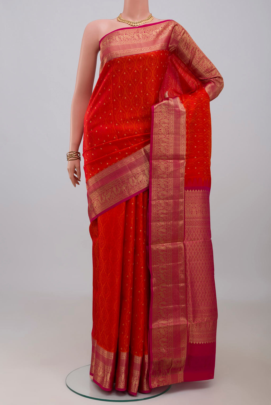 Orange Soft Silk Saree with Jacquard With Zari Butta on the body and Zari Border.  displayed on a mannequin
