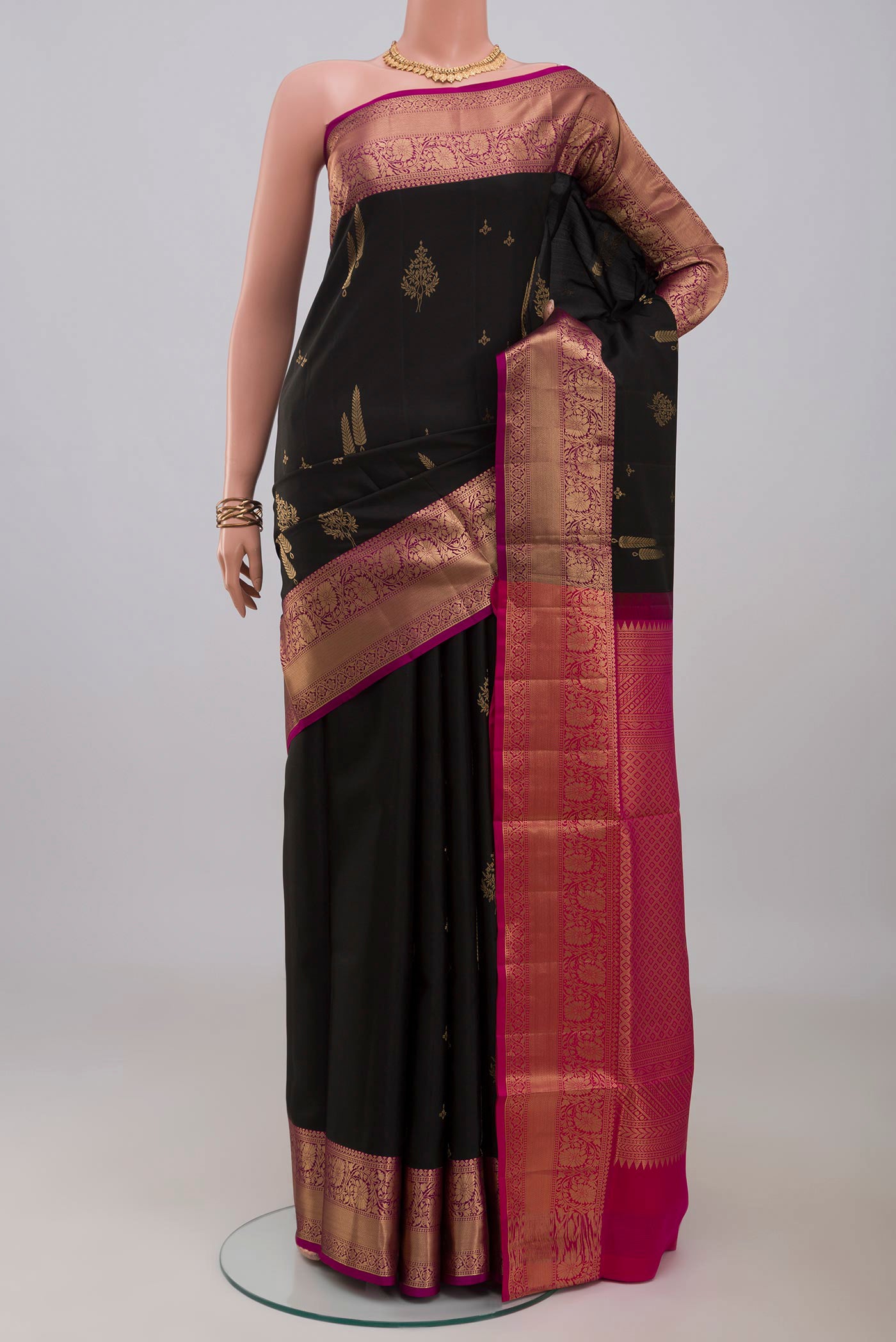 Black Soft Silk Saree with Zari Butta on the body and Zari Border.  displayed on a mannequin