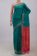 Blue Soft Silk Saree with Zari Butta on the body and Thin Zari Line.  displayed on a mannequin