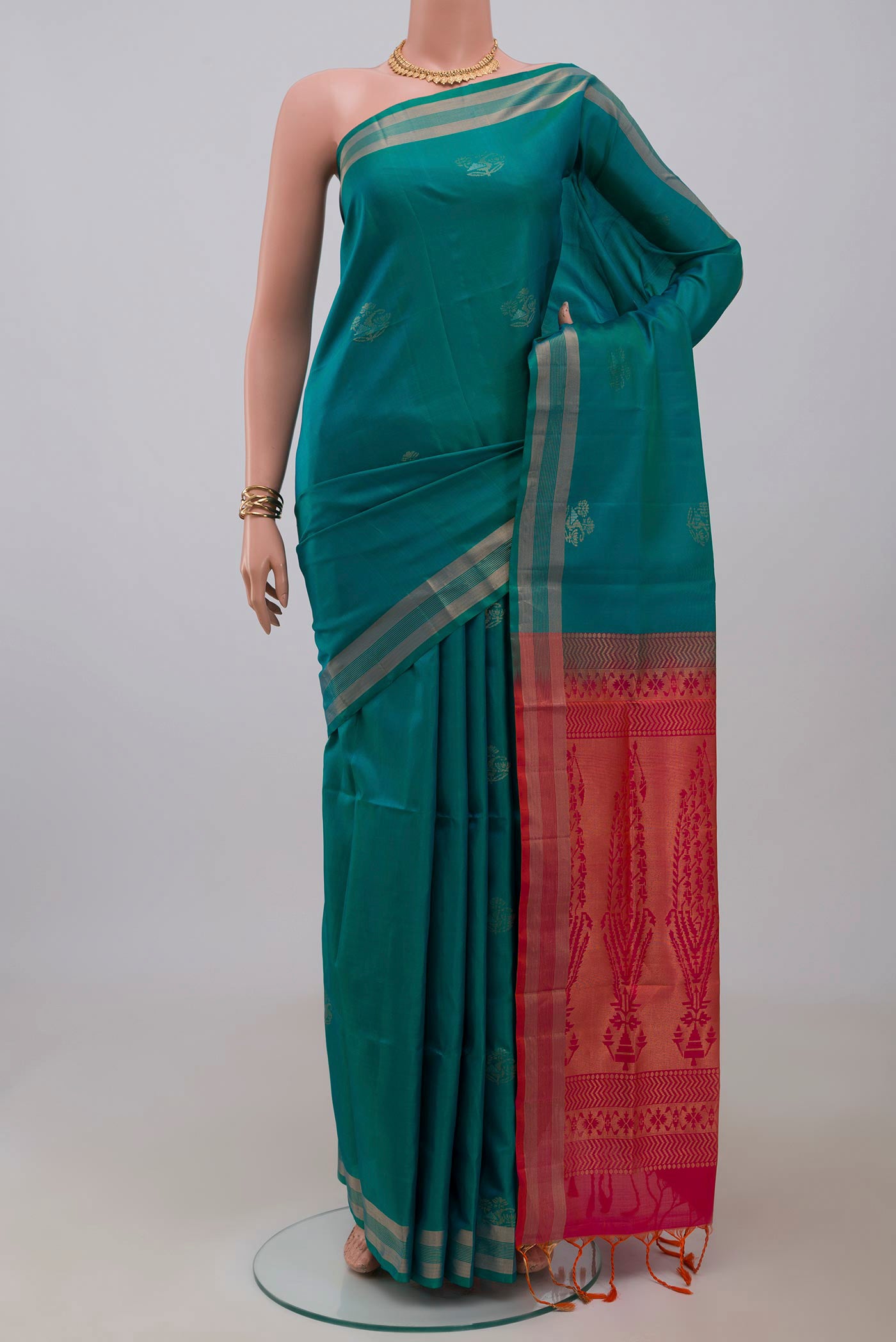 Blue Soft Silk Saree with Zari Butta on the body and Thin Zari Line.  displayed on a mannequin