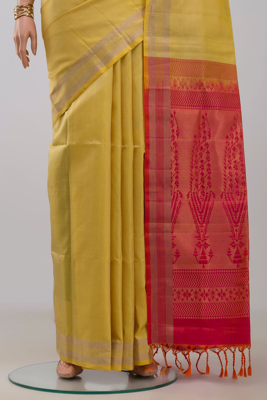 Pleats and pallu of Yellow Soft Silk Saree with Zari Butta on the body and Zari Border. 
