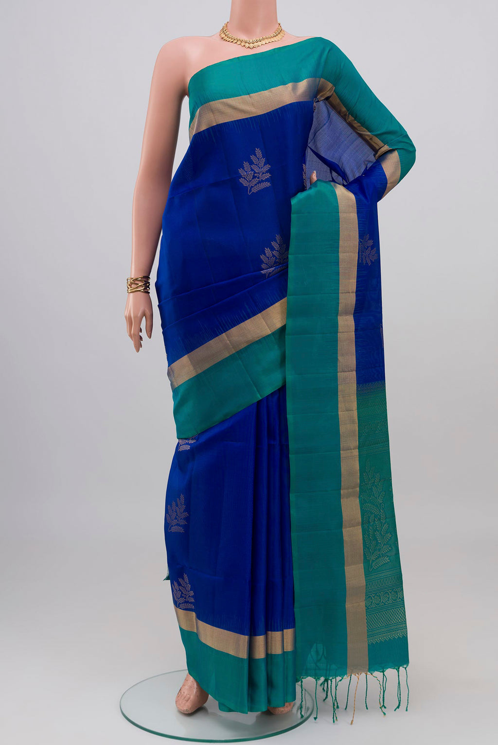 Royal Blue Soft Silk Saree with Zari Butta on the body and Thin Zari Line.  displayed on a mannequin