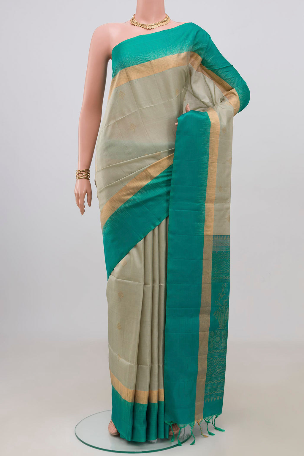 Beige Soft Silk Saree with Zari Butta on the body and Fancy Border.  displayed on a mannequin