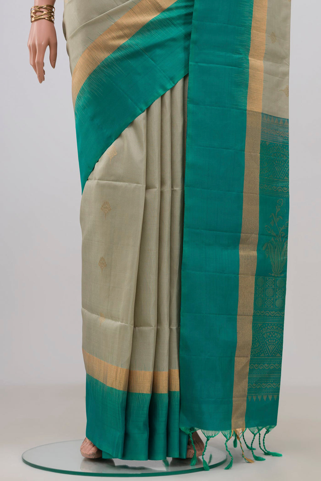 Pleats and pallu of Beige Soft Silk Saree with Zari Butta on the body and Fancy Border. 