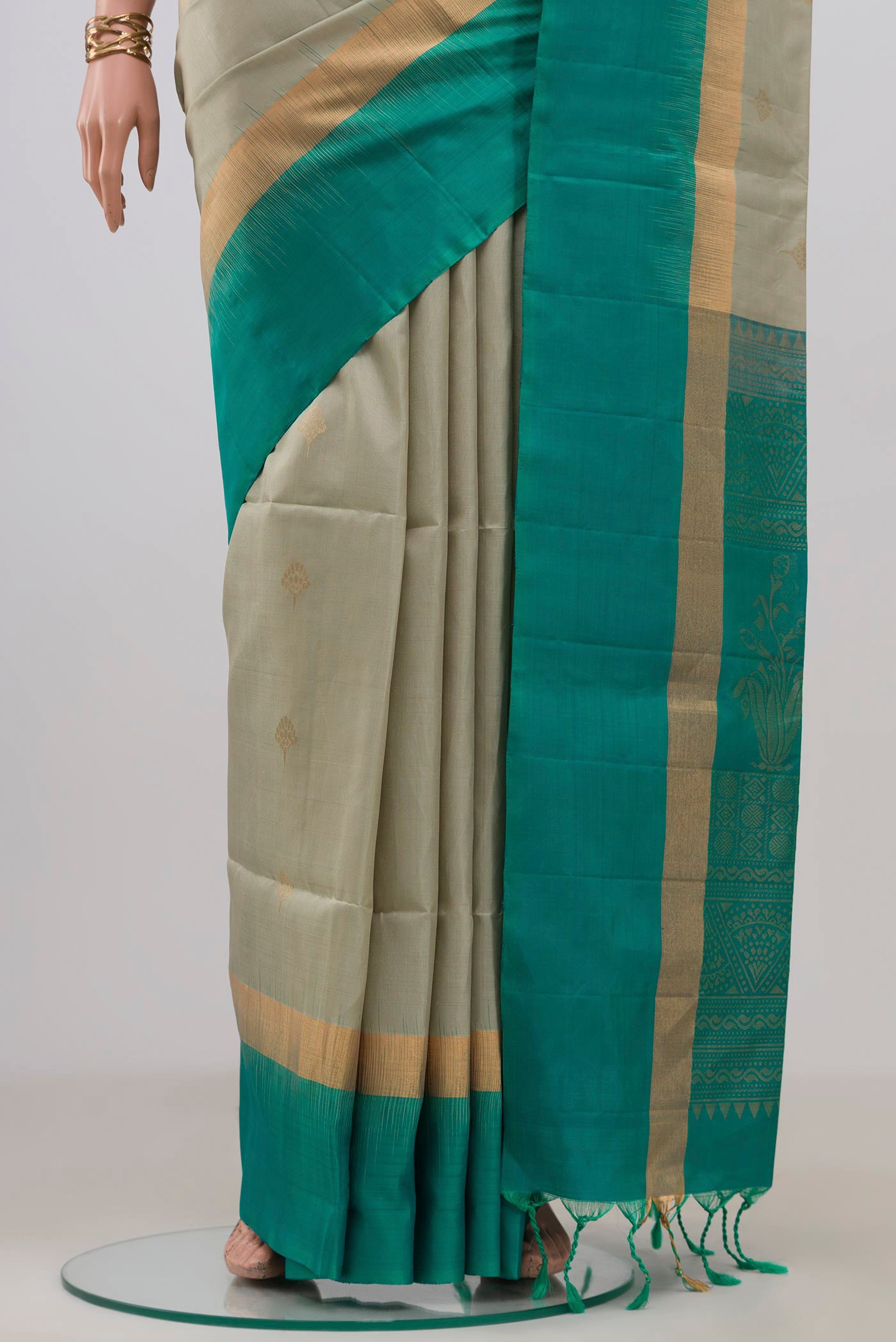 Pleats and pallu of Beige Soft Silk Saree with Zari Butta on the body and Fancy Border. 