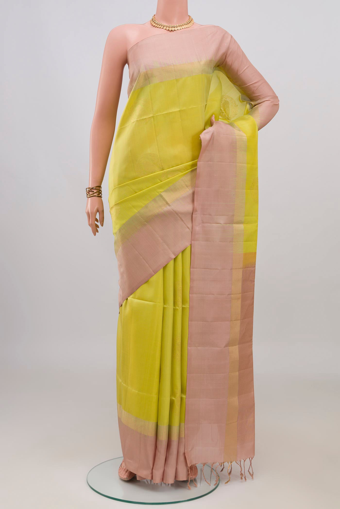 Pure Silk Lemon Yellow Soft Saree with Zari Butta on the body and Plain Border.  displayed on a mannequin