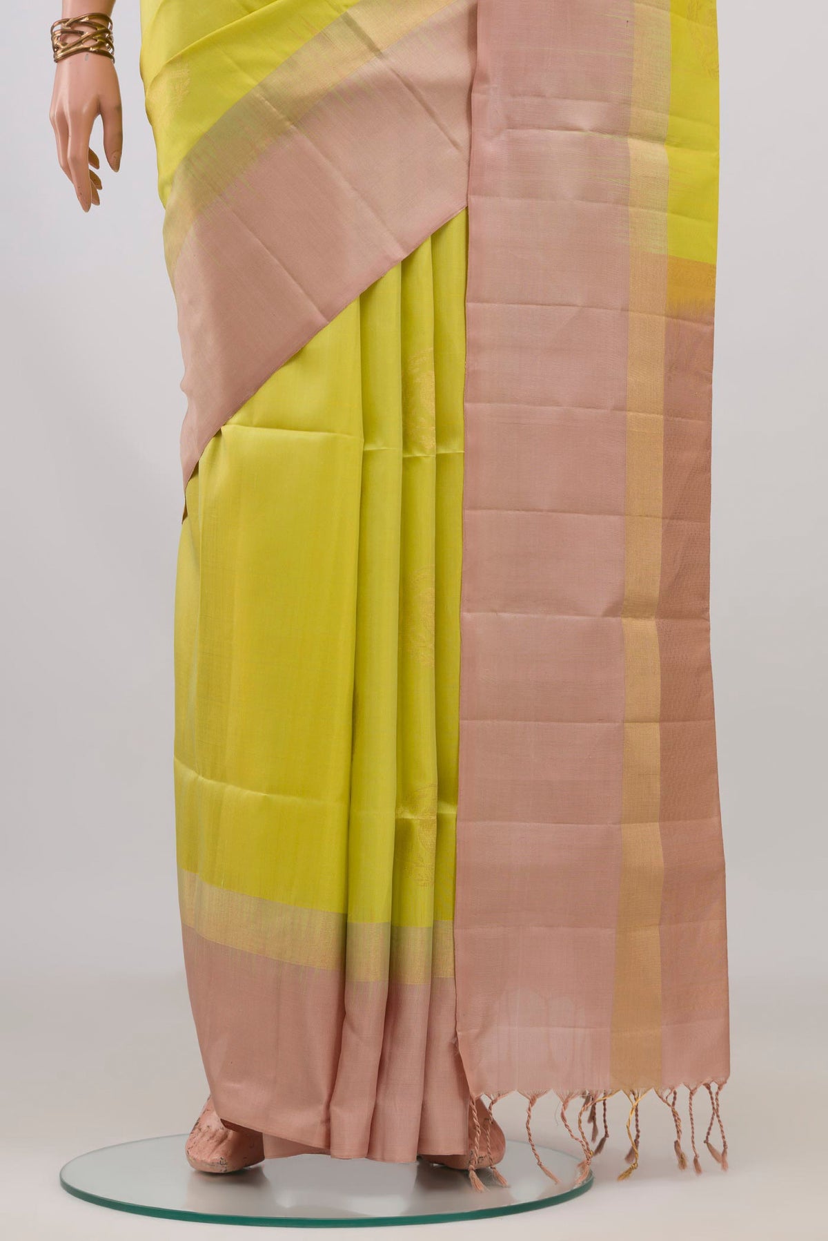 Pleats and pallu of Pure Silk Lemon Yellow Soft Saree with Zari Butta on the body and Plain Border. 