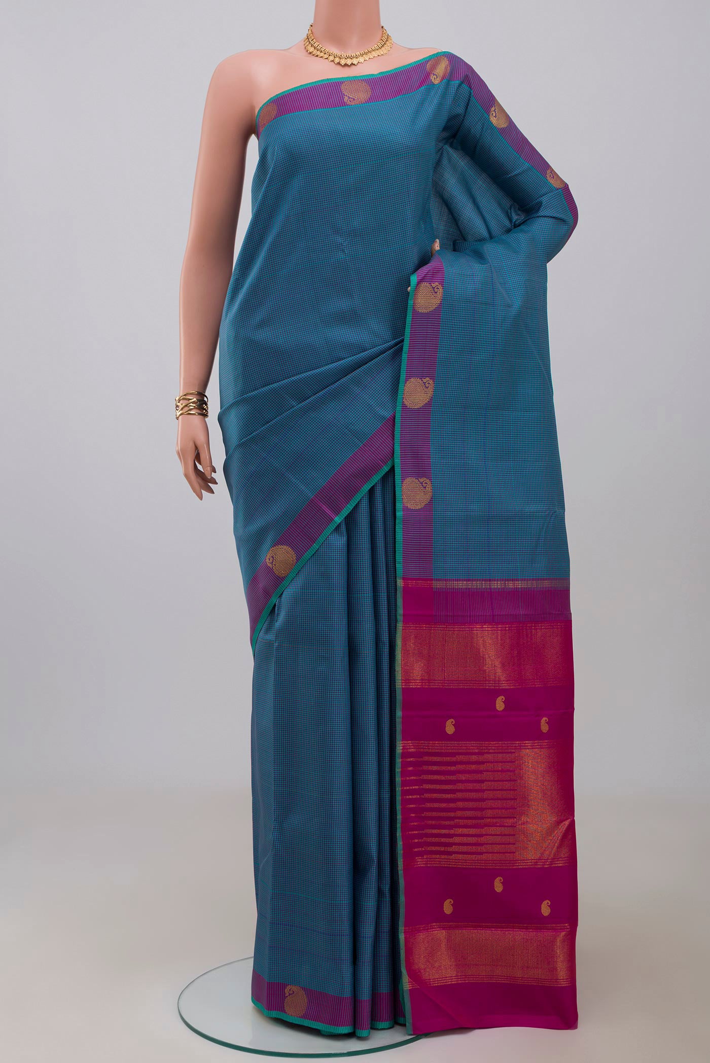 Pure Silk Pure Zari Blue Kanjivaram Saree with Checked design on the body and Fancy Border.  displayed on a mannequin