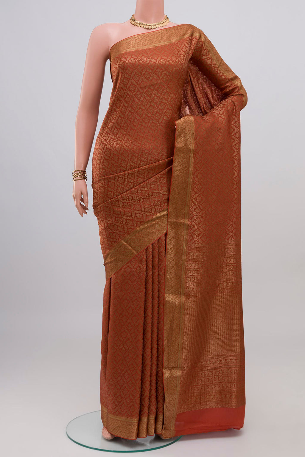 Rust Mysore Crepe Saree with Zari Brocade on the body and Zari Border.  displayed on a mannequin