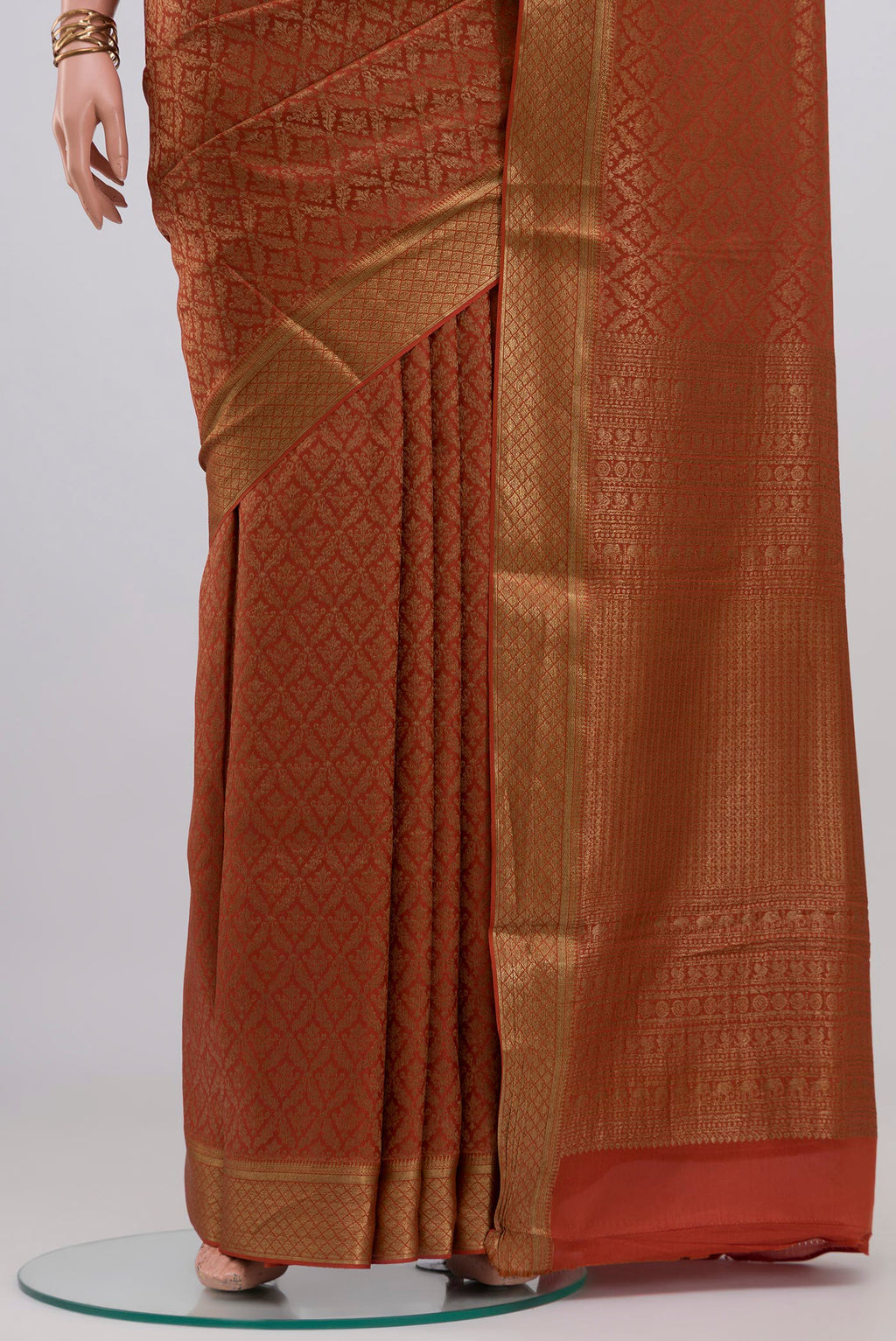 Pleats and pallu of Rust Mysore Crepe Saree with Zari Brocade on the body and Zari Border. 