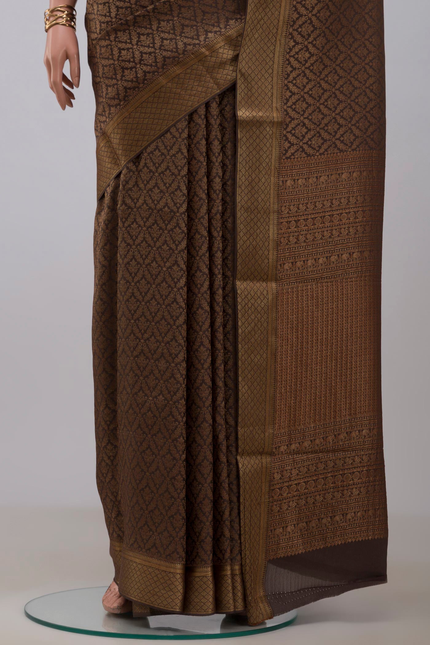 Pleats and pallu of Brown Mysore Crepe Saree with Zari Brocade on the body and Zari Border. 