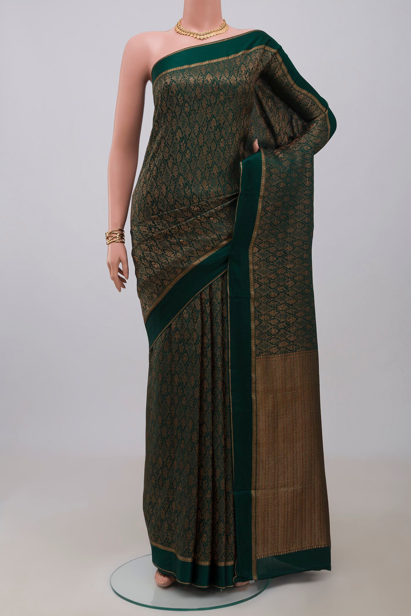 Bottle Green Mysore Crepe Saree with Zari Brocade on the body and Thin Zari Line.  displayed on a mannequin