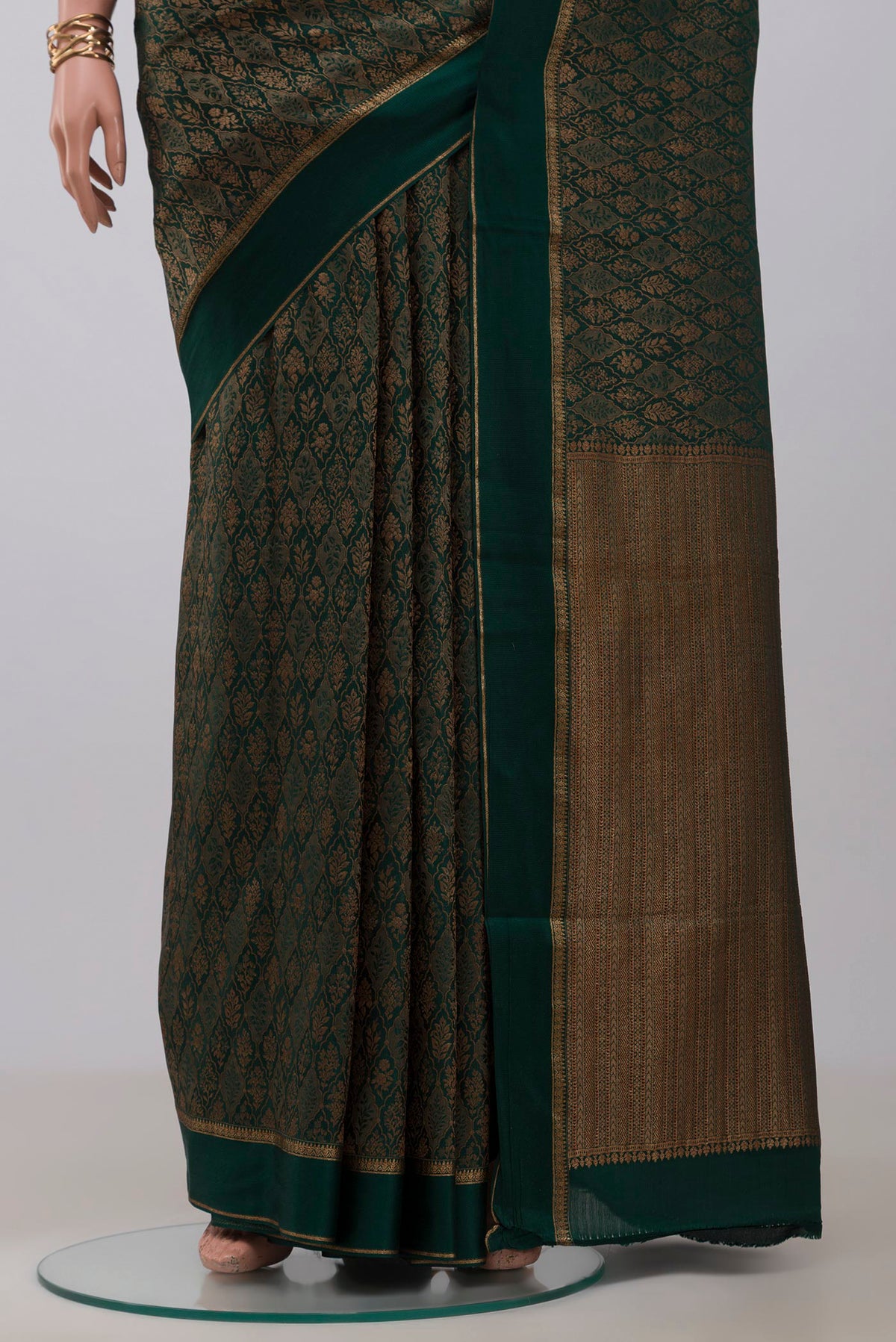 Pleats and pallu of Bottle Green Mysore Crepe Saree with Zari Brocade on the body and Thin Zari Line. 