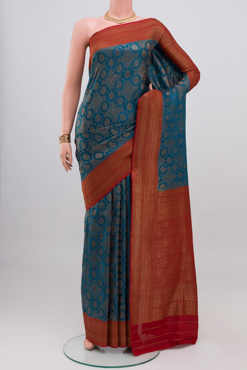 Blue Crepe Saree with Zari Brocade on the body and Zari Border.  displayed on a mannequin